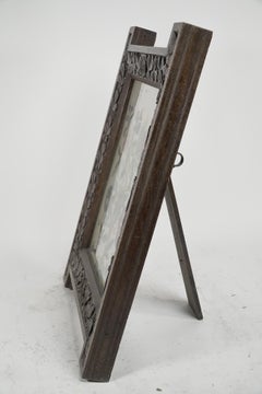 A large Gothic Revival picture frame with stylized floral carvings