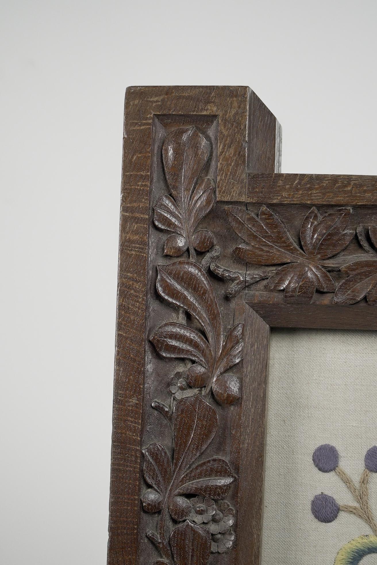 Wood A large Gothic Revival picture frame with stylized floral carvings For Sale