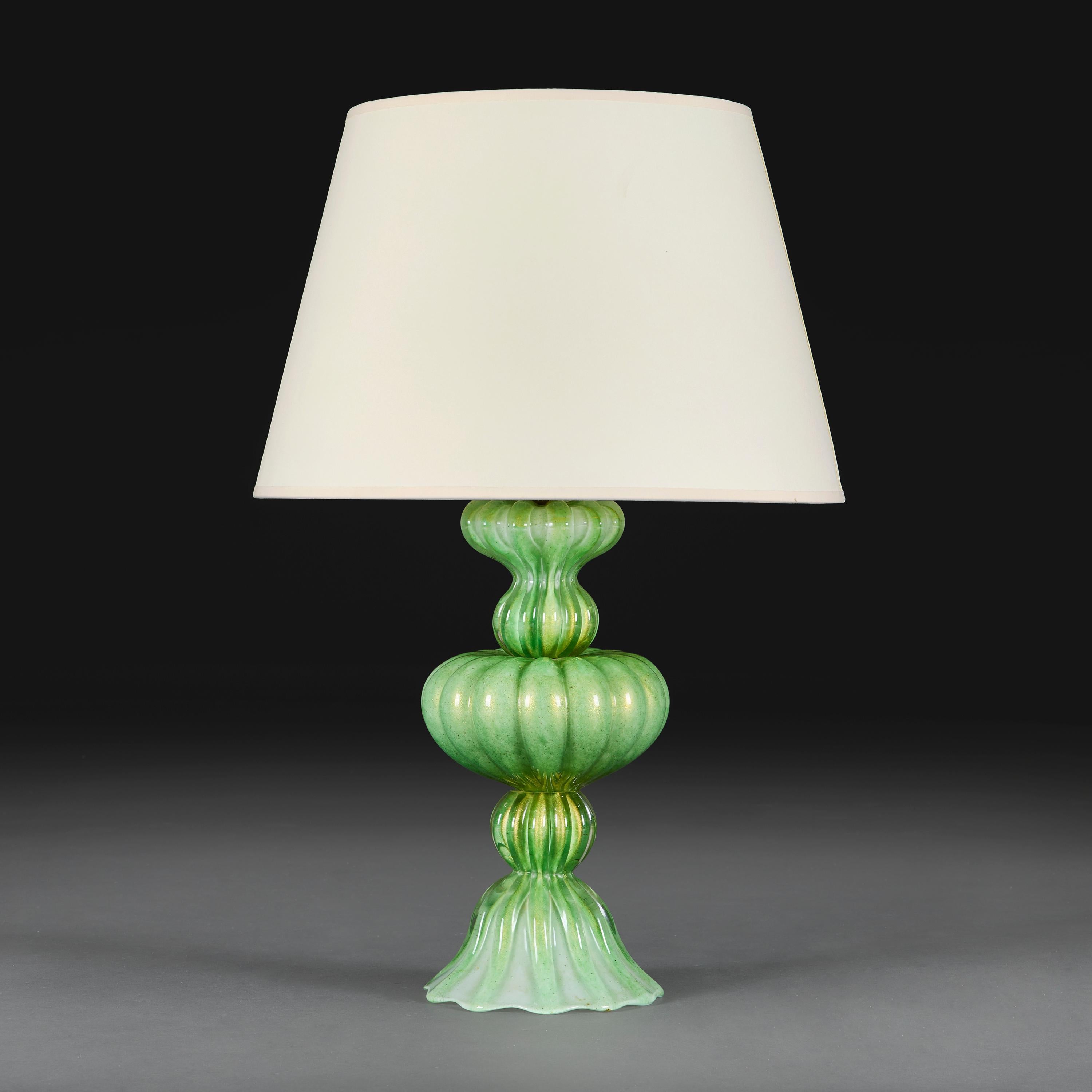 Italy, circa 1940

A large twentieth century green Murano glass lamp, the sinuous gadrooned body hand blown in segments with Aventurine inclusions throughout, in the manner of Seguso.

Height 39.00cm
Diameter 19.00cm

Please note:

Lampshade not