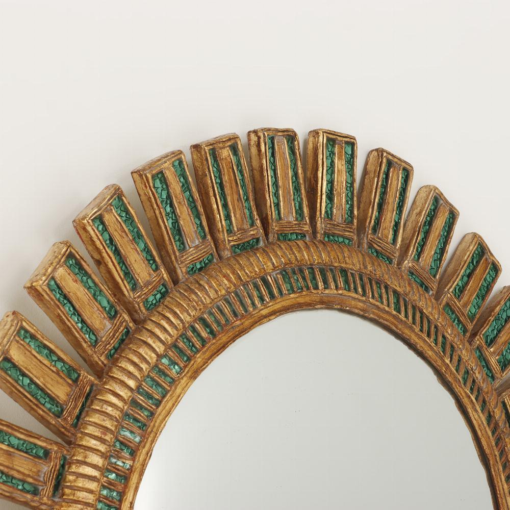 A large green glass and resin convex sunburst mirror in the manner the 
