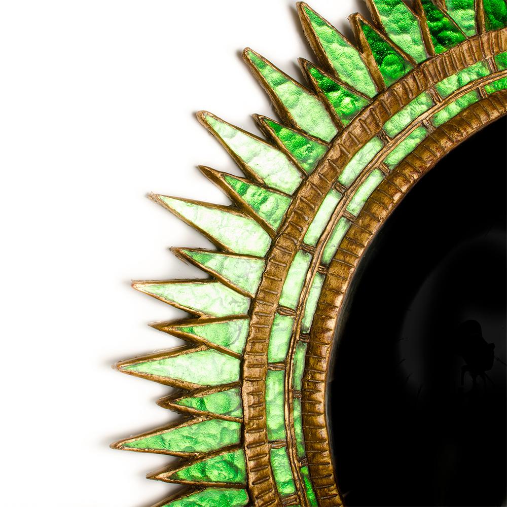 A large green glass, gilt wood and gesso convex 