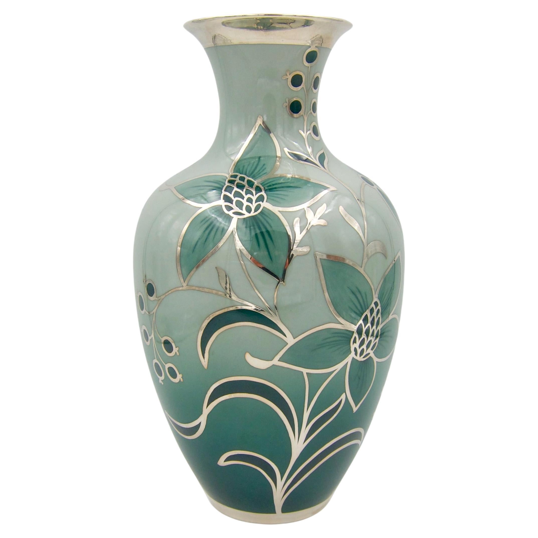 A large green porcelain vase with silver overlay by Friedrich Wilhelm Spahr for Edelstein Porcelain. The vintage vase in the Art Deco style was made in Germany during first half 20th century. The porcelain body is glazed inside and out in shades of