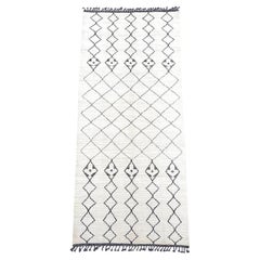 A large handwoven Moroccan Beni Ourain wool berber rug with diamond pattern