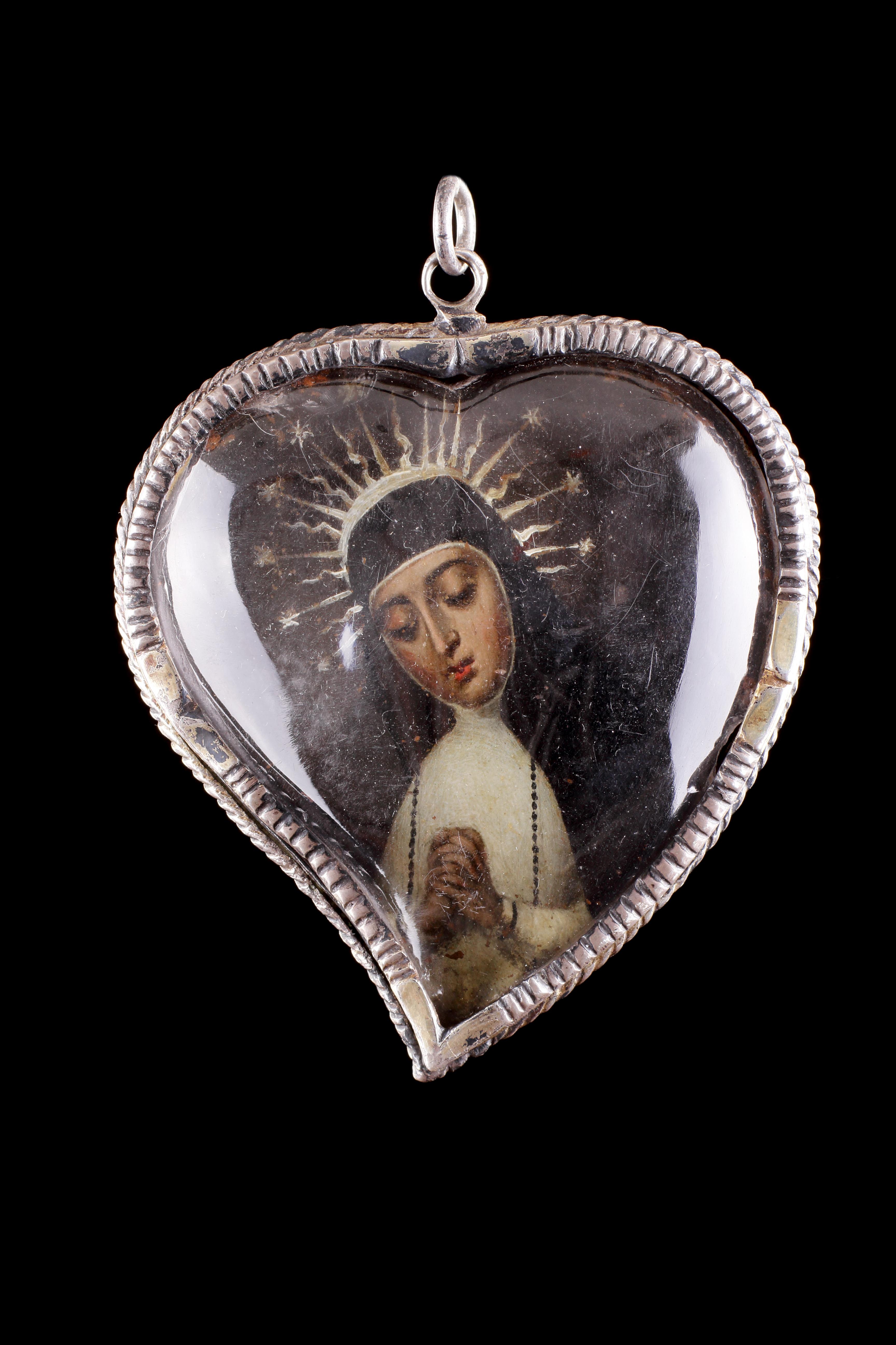 A Large Heart Shaped Rock Crystal Silver Mounted Reliquary
Silver, Rock-Crystal, Polychrome 
Spain 
17th Century 

SIZE: 9cm high, 7.5cm wide, 1.5cm deep - 3½ ins high, 3 ins wide, ⅔ ins deep 