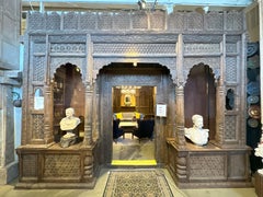 A Large Indian Architectural  Facade With Doorway and Flanking Window Seats