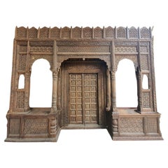 A Large Indian Architectural  Facade With Doorway and Flanking Window Seats