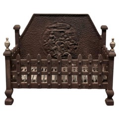 A Large Iron Fire Grate The fire has a decorative high back