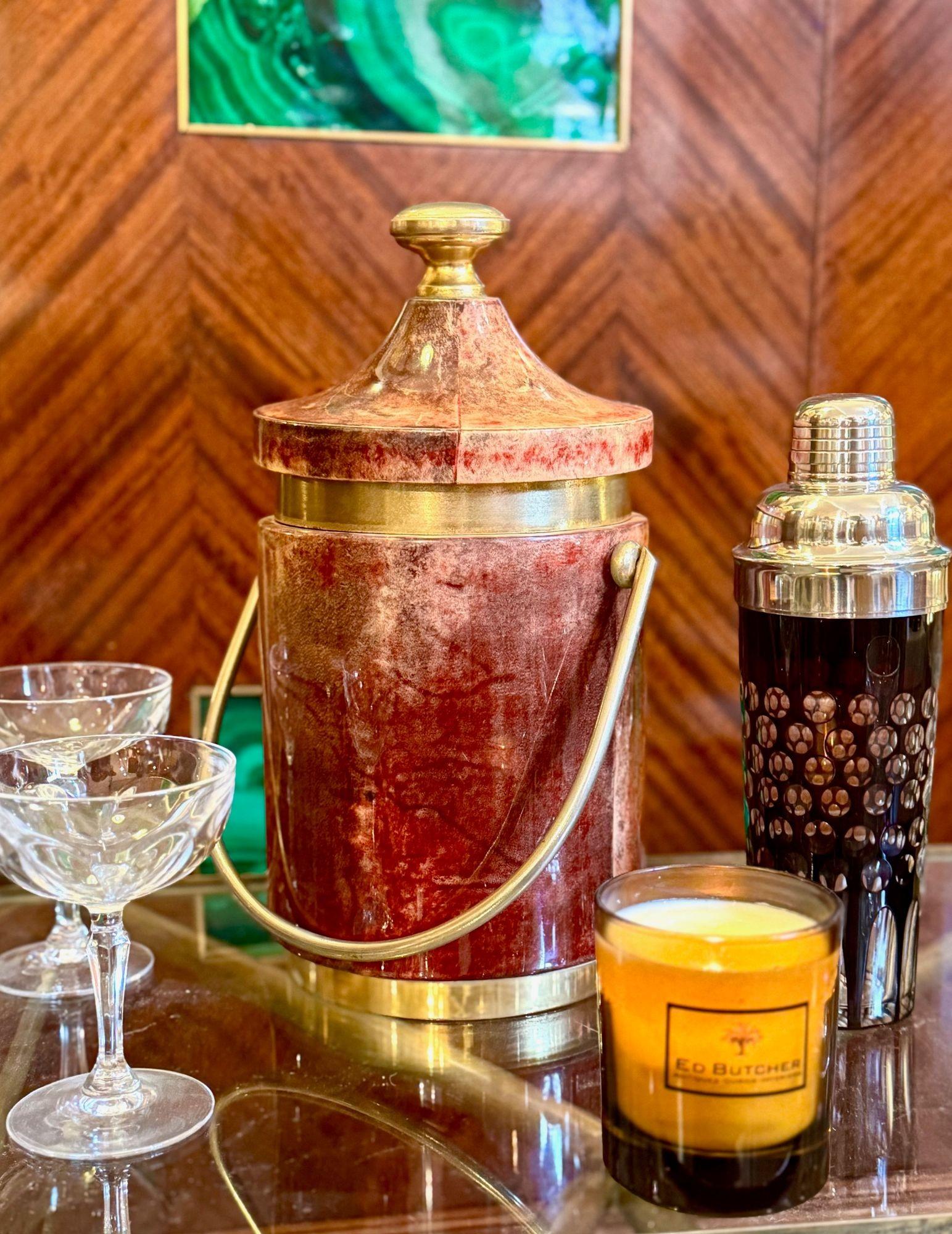A large Italian 1960s red and pink lacquered goat skin ice bucket by Aldo Tura with brass detail and handle. With origianl bronze glass thermos interior. A wonderful  statement piece and perfect for keeping your ice frozen. 