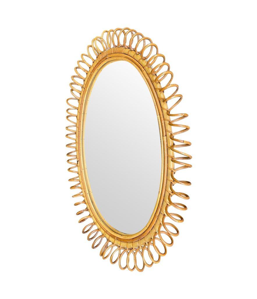 Late 20th Century A large Italian 1970s bamboo oval mirror with spiral frame by Franco Albini