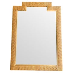 A large Italian 1970s woven rattan mirror with stepped top detail