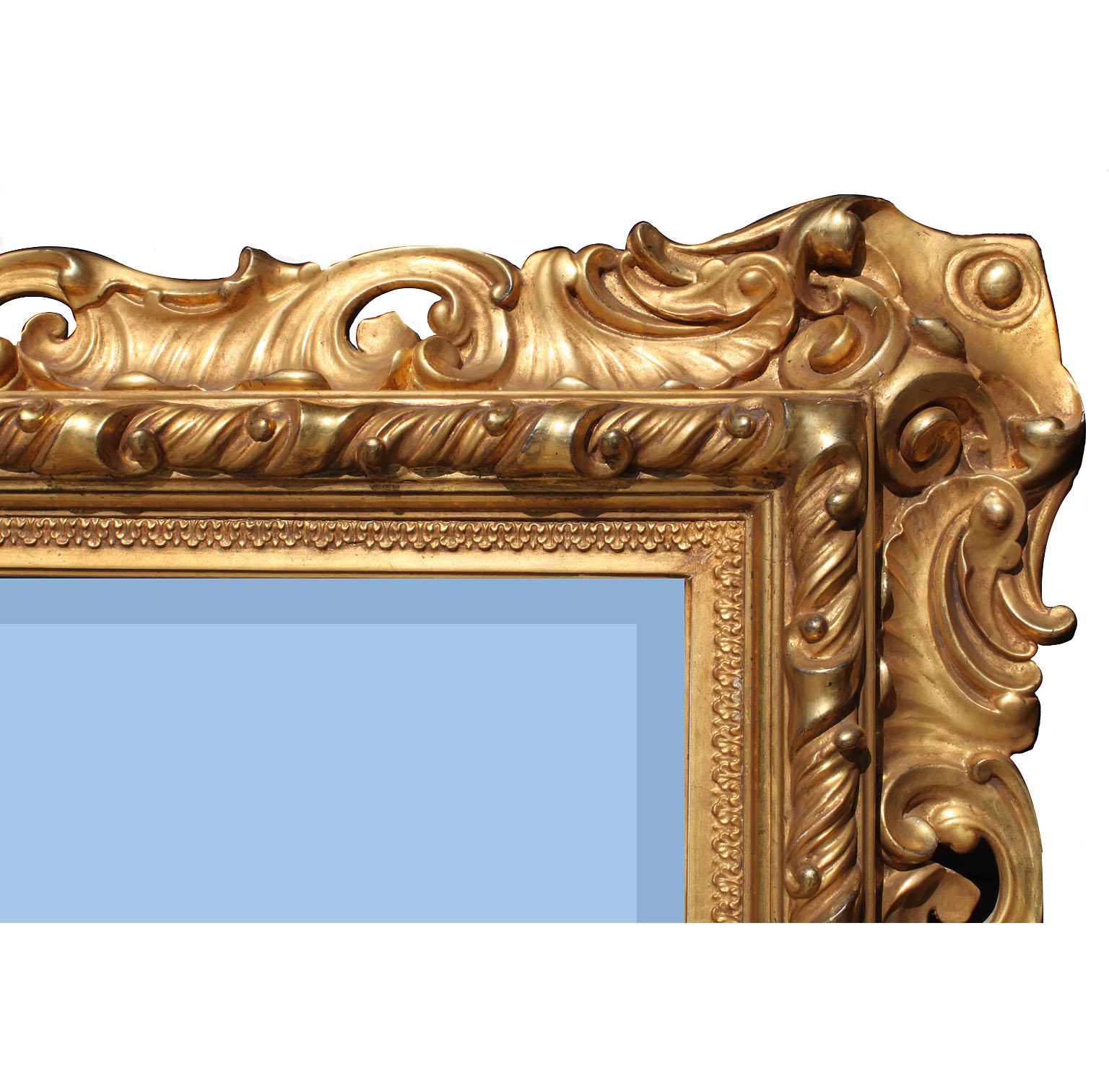 A fine and large and impressive Italian 19th century Baroque Revival style giltwood carved mirror frame. The ornately carved rectangular shaped frame, with floral, scrolled and shell carved frame, which can be hanged either vertically or