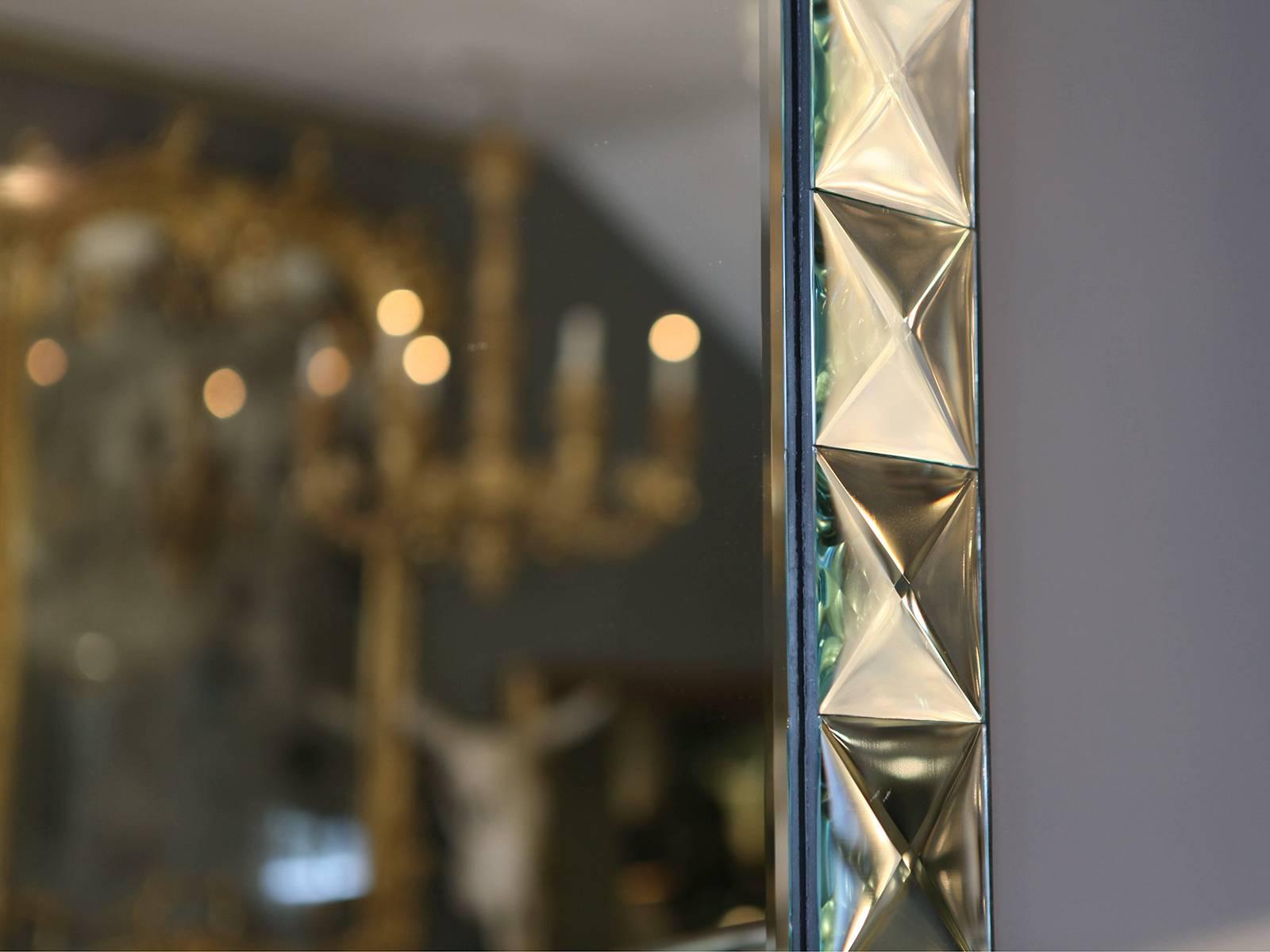 A large bevelled mirror with square raised diamond shaped border, Italian, late 20th century.