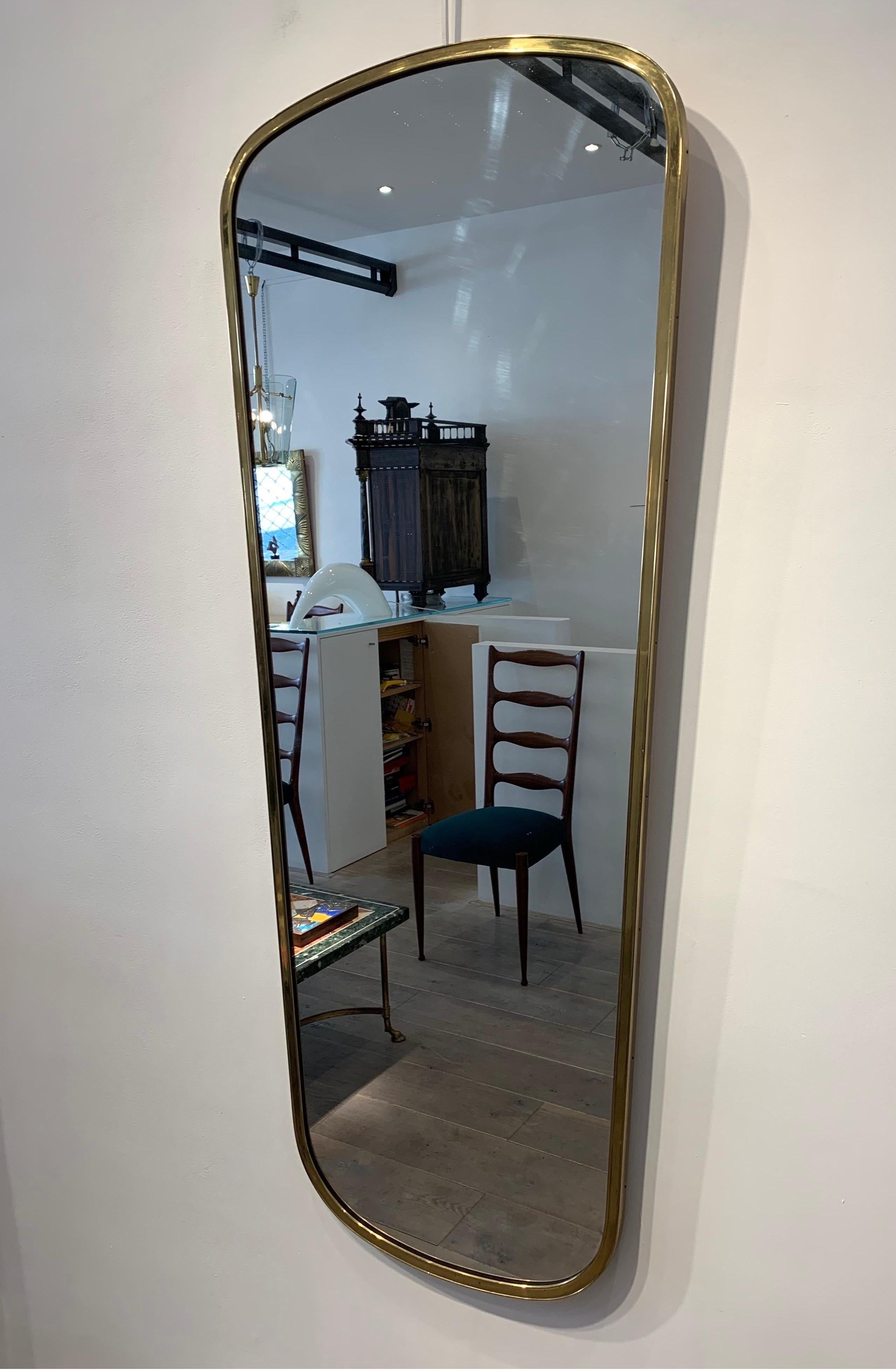 The mirror is the style of Gio Ponti mirror. It has its beautiful patina of the time. The size is larger than usual mirror f of this type with a height of 135cm.
