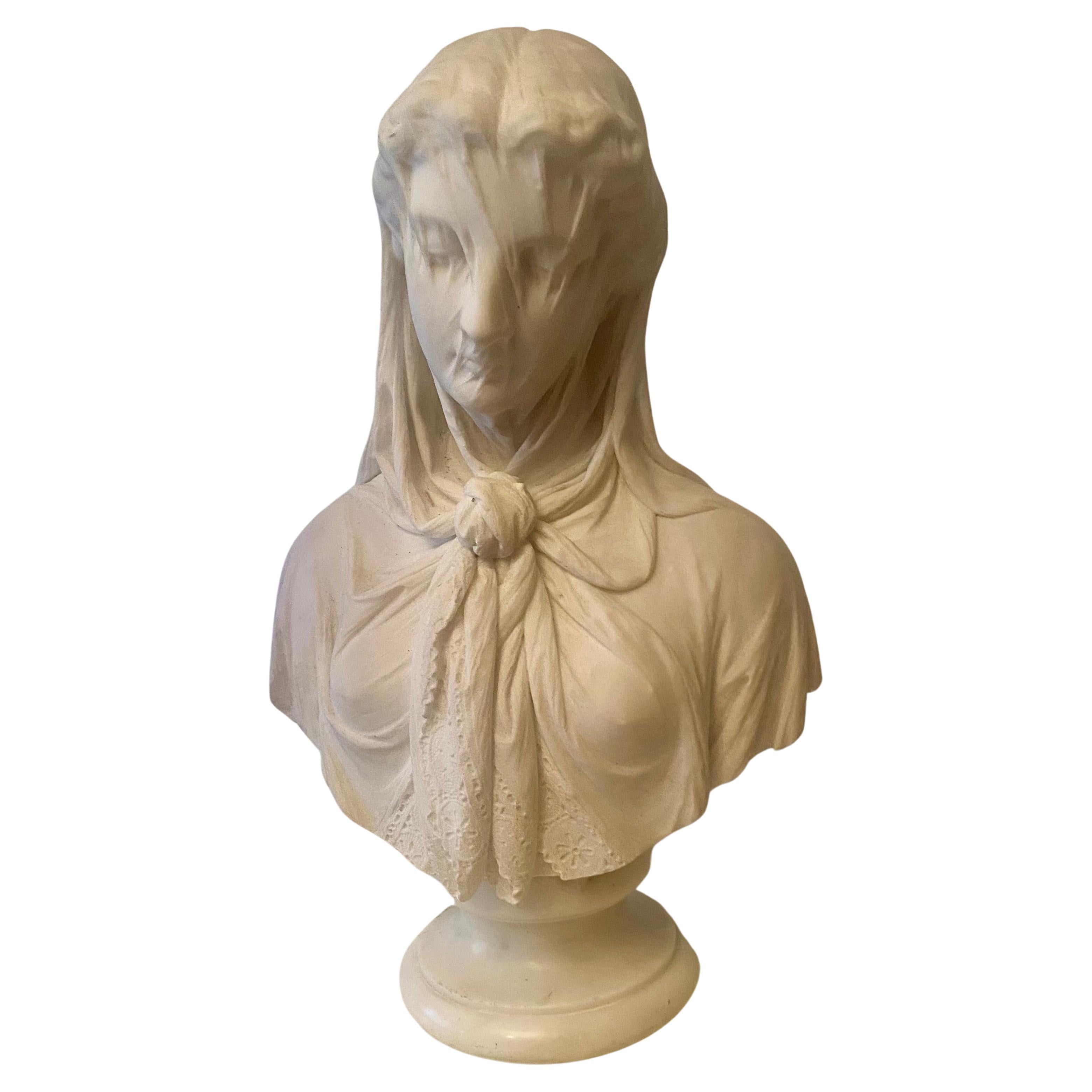 This is a high quality solid marble bust, though one of a kind, is particularly finely composed and delicately carved. Although she does not wear a wreath of flowers, this young woman, with the modest tilt of her head and the veil with its elaborate