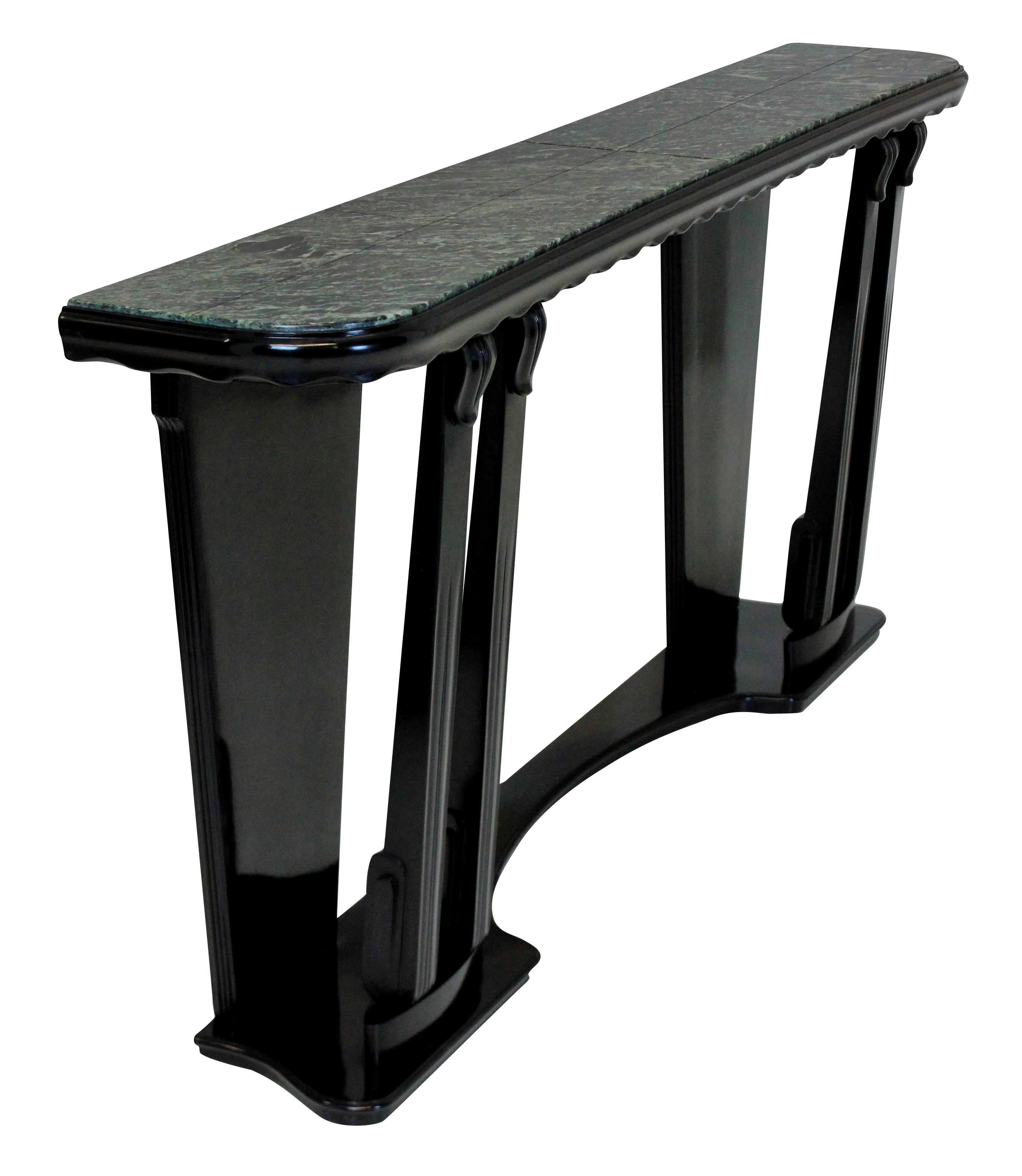 A large and stylish Italian console table in ebonized carved fruitwood, with an antico verdi marble top.

 