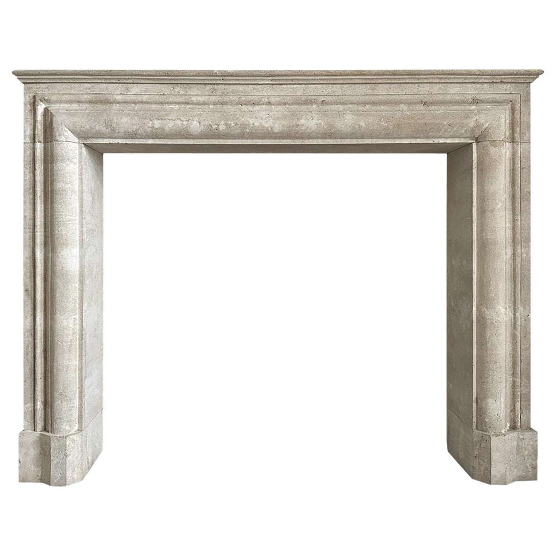 A large Italian Travertine Stone Bolection Fireplace Mantel