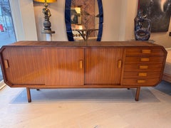 A large Italian walnut sideboard with pencil reed and curved waterfall edges