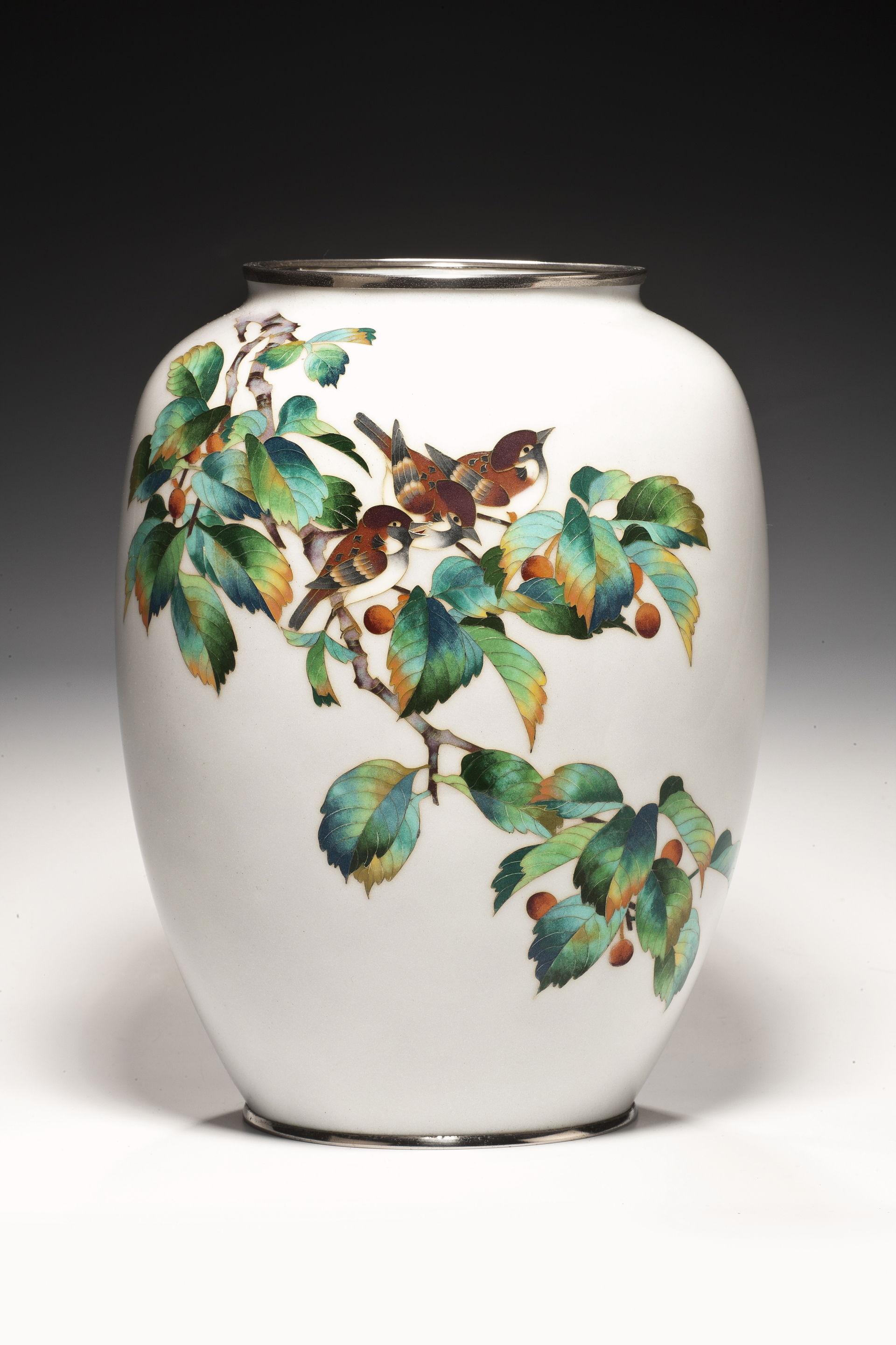 This vase has three sparrows perched on a cherry branch. In varietgated polychrome cloisonne on a white ground. Showa period.