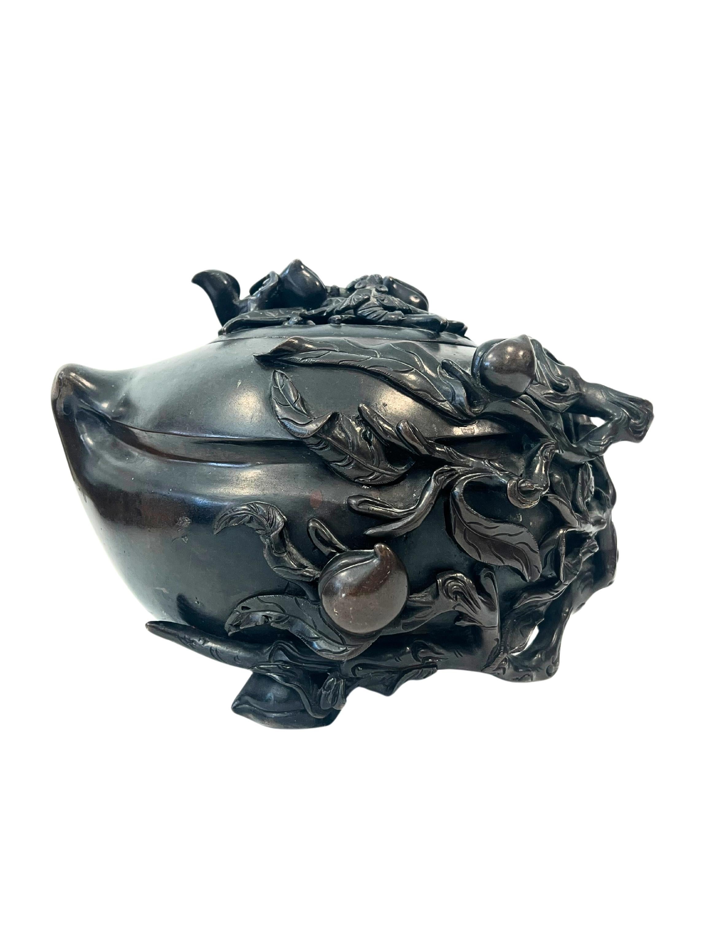 A Large Japanese Meiji Period Bronze Decorated Censor and Cover. 

Having an unusual shaped base with applied foliage and branches, the top decorated with bats amongst fruit. 

Dimensions Height: 6 3/8