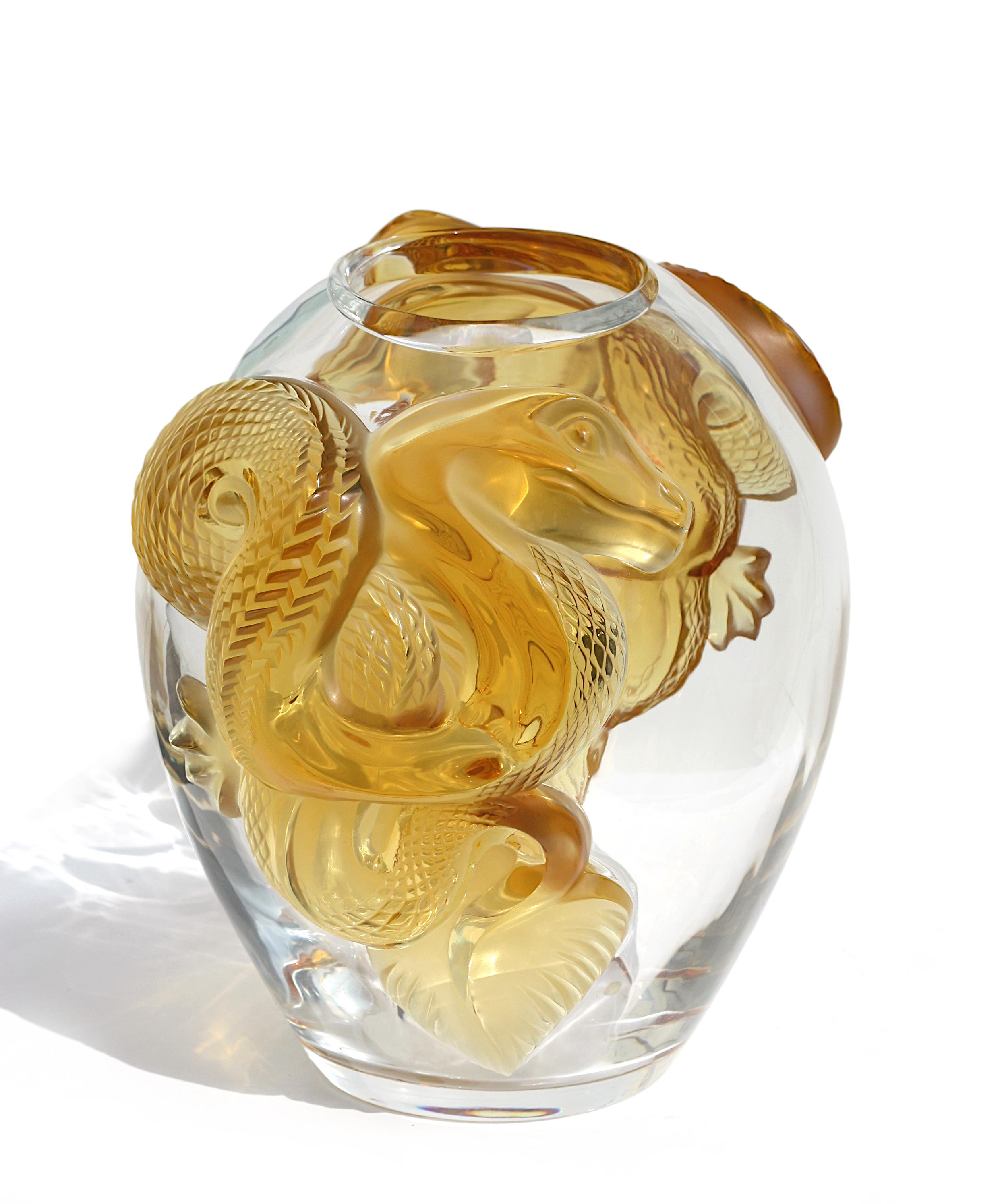 A large Lalique Crystal Serpent pattern vase,
Modern, serpents are delicately engraved into the imposing flanks of the serpent vase, their scales emphasized by the brilliance of crystal,
engraved 'Lalique France' and numbered 69/99
approximately