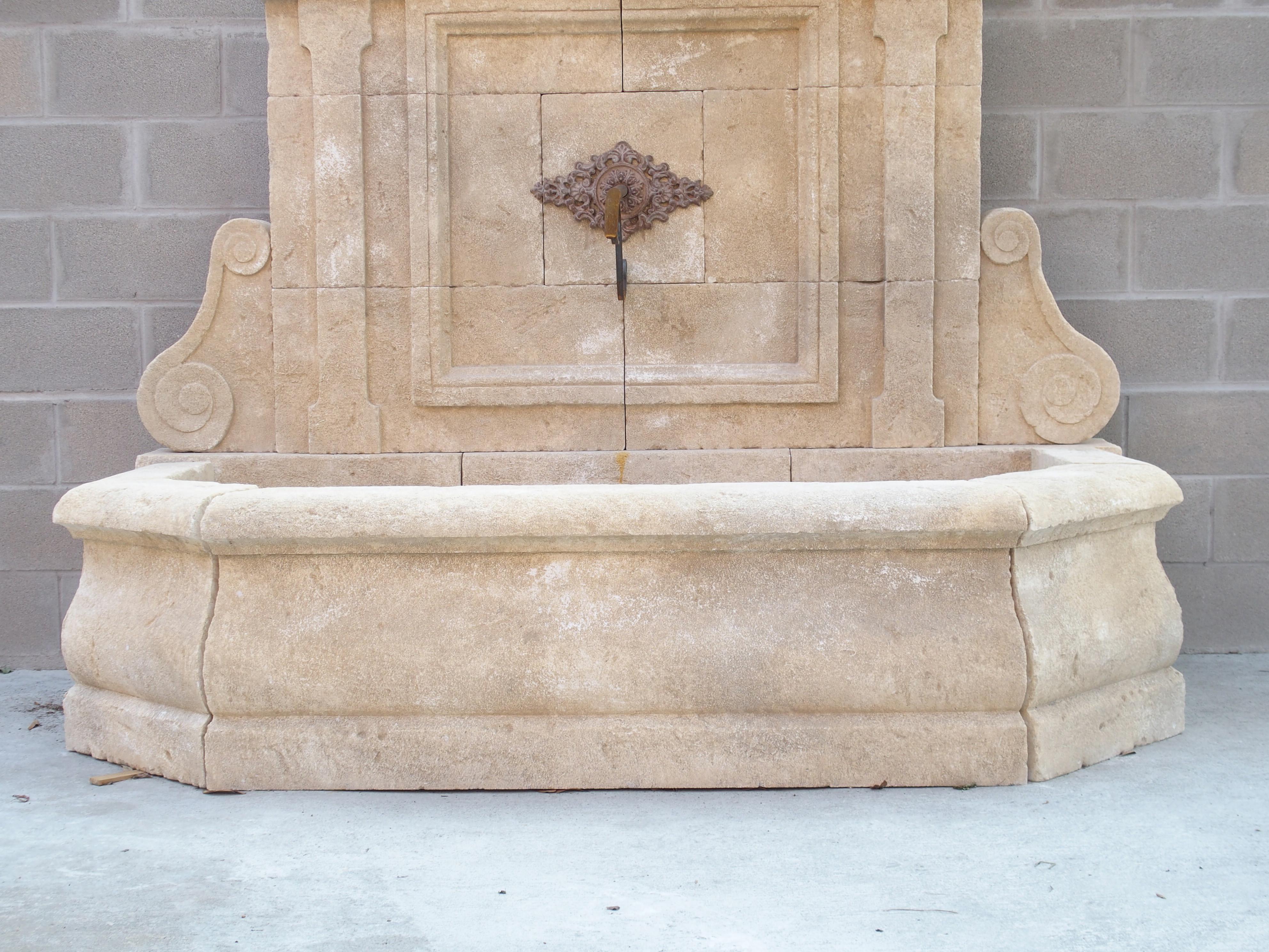 Classically inspired and hand-carved in Le Vaucluse, a department in Southern France within the Provence region, this majestic wall fountain is comprised of 22 pieces of Estaillade limestone.

The large crown features cavetto molding, sometimes
