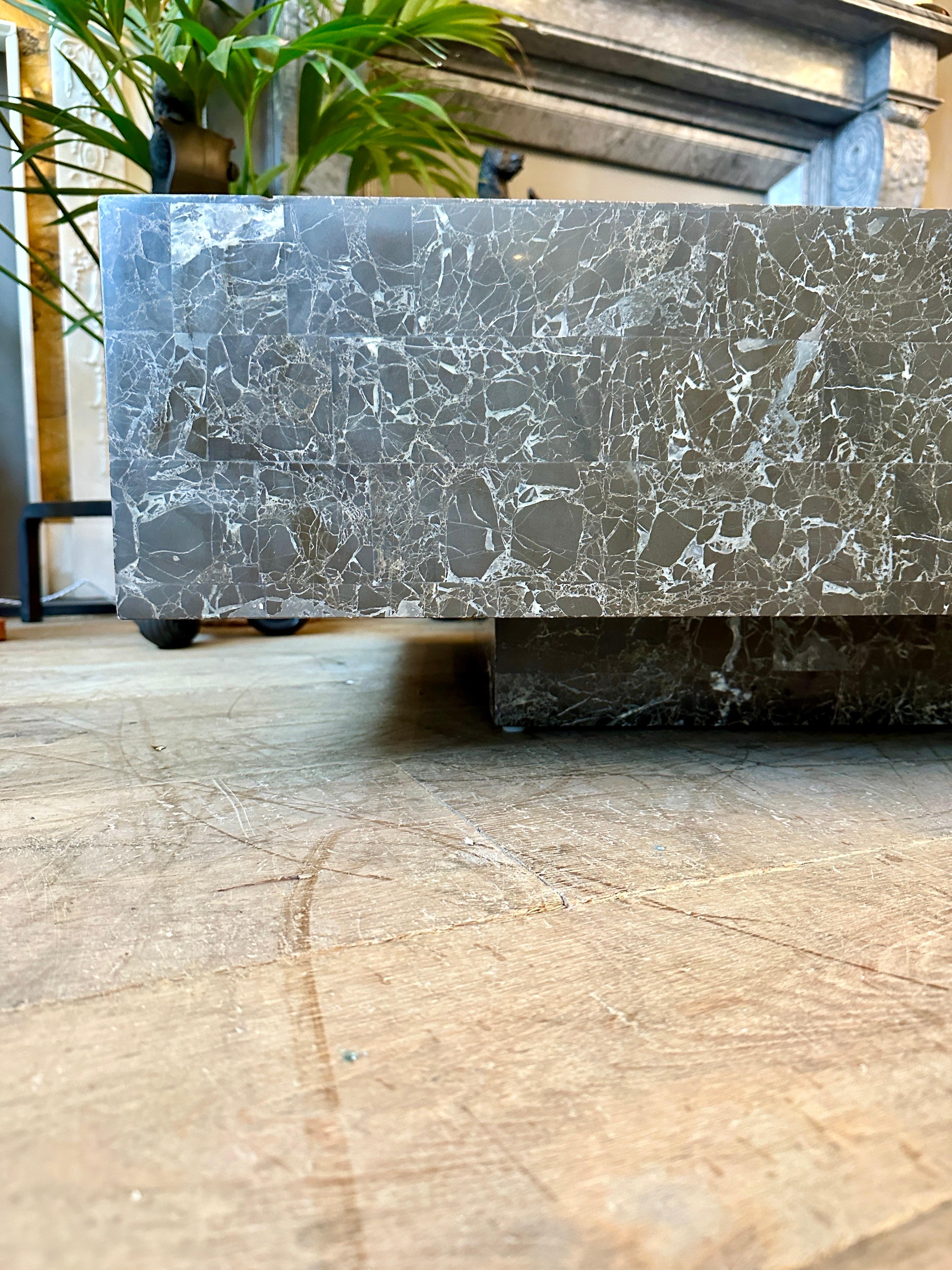 A large and low cocktail table in Grey tessellated Emperador Marble, the floating top sitting on the same finish on the base. Classic Maitland smith design. The marble forming a classic modern design table. Versatile, functional and good proportions