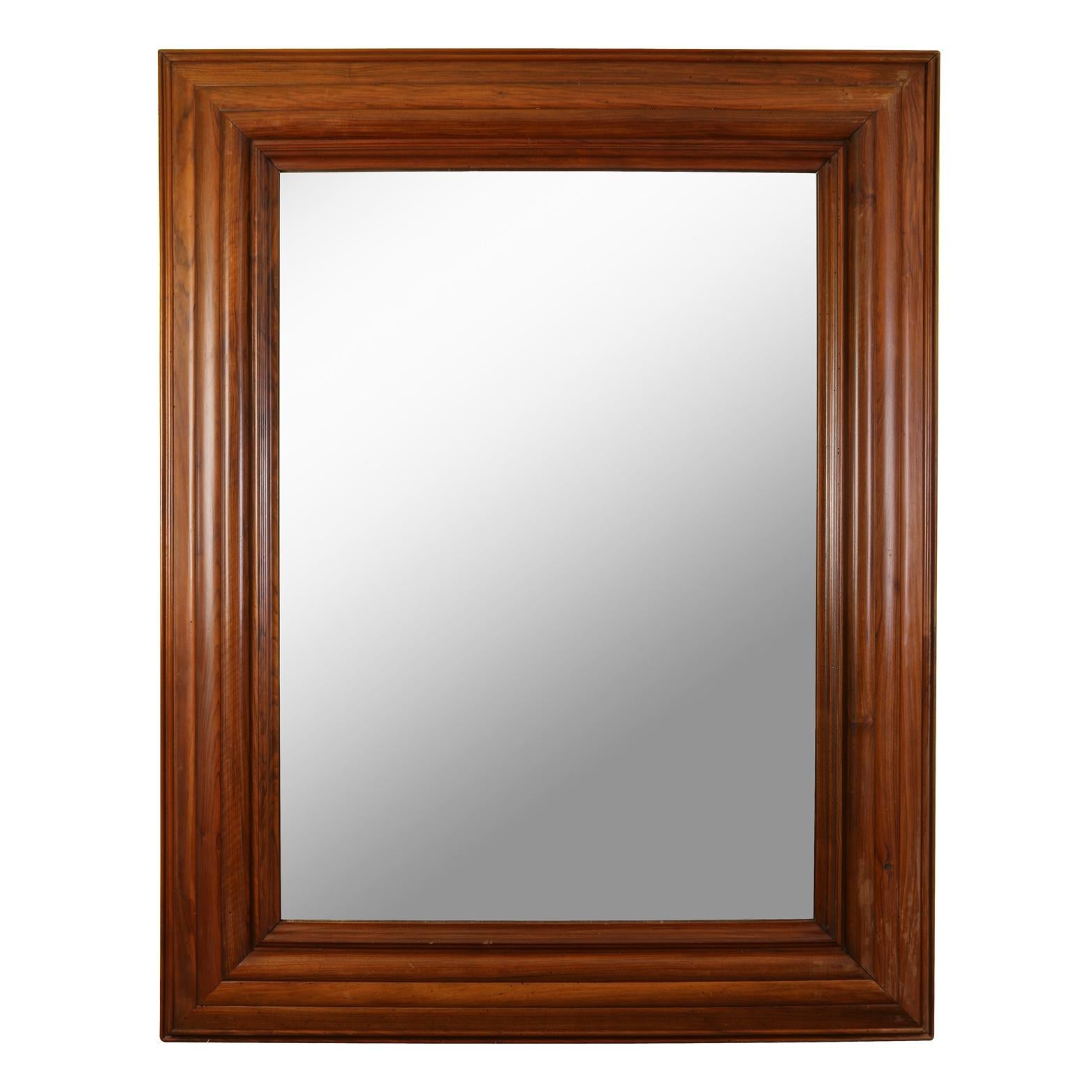 What makes this mirror a standout is its large scale and its rich mahogany frame.  With its lovely molded frame, the mirror is a statement piece in any space.
