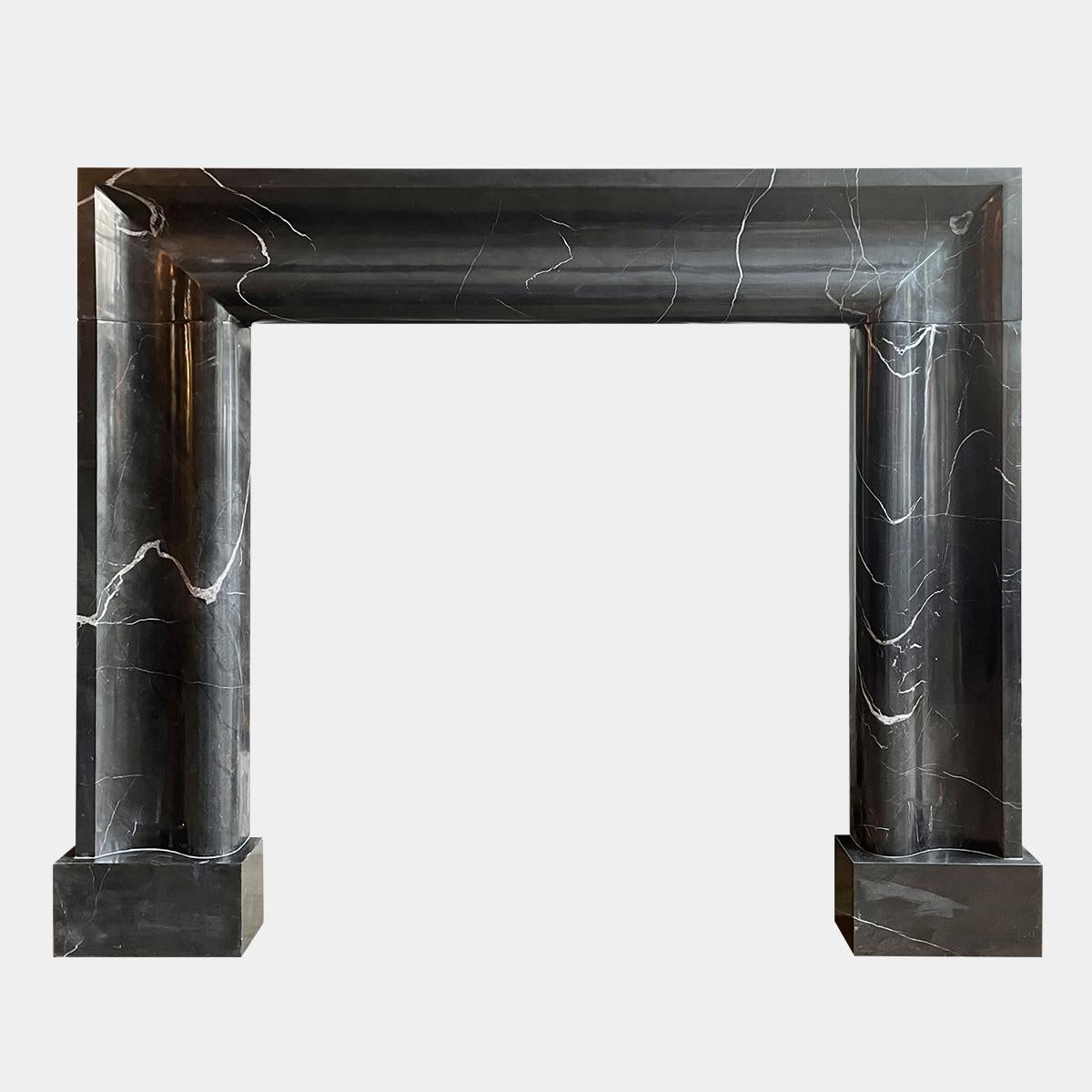 A large Bolection moulded fire surround in Nero Marquina marble. This surround has a wide leg and header moulding supported on large rectangular foot blocks.

Opening Size 

Measures: 101cm w by 102cm h.