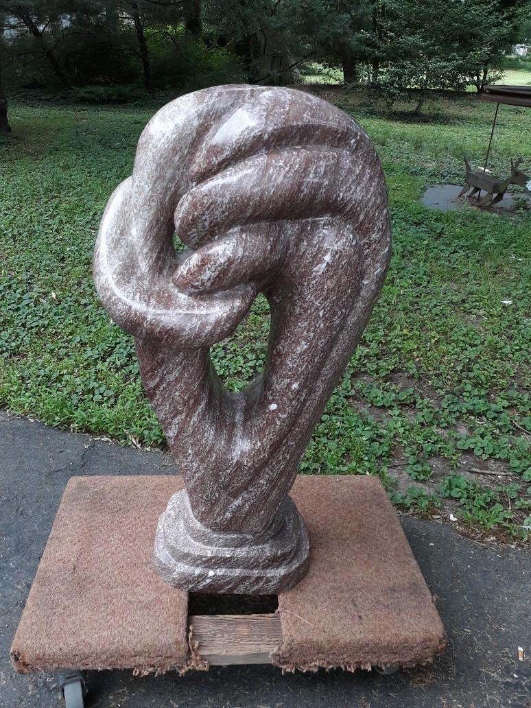 An elegant hand carved deep rouge marble mid century modern abstract sculpture. The shapely sculpture suggesting an abstract human form with a beautifully polished surface. Recently removed from a Princeton NJ estate.