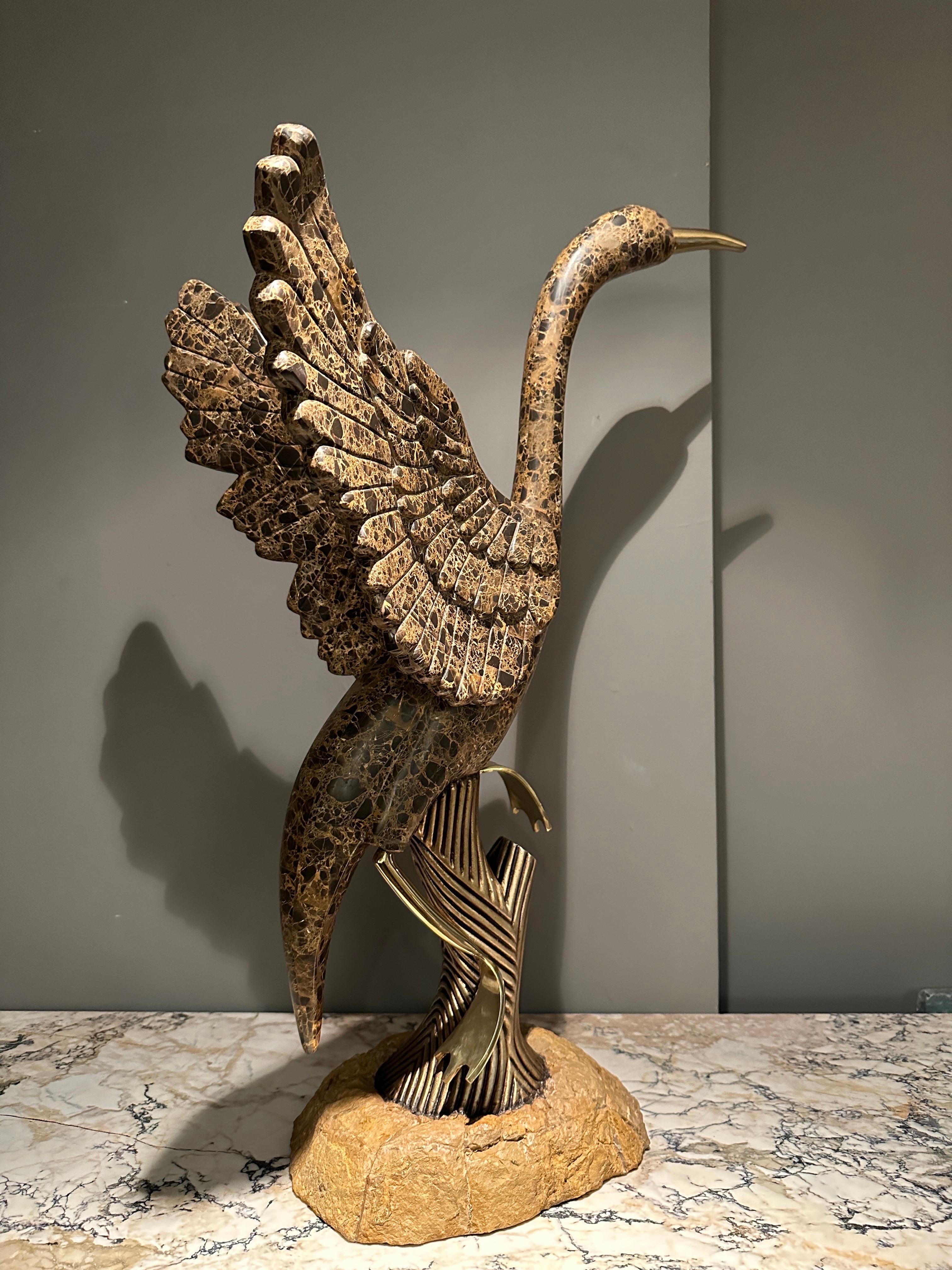 A large perched crane bird sculpture in tessellated Emporador marble and brass by Maitland Smith USA. Great scale, size and caught in perfect movement this modernist stylised sculpture capturing this Bird very well. 

The use of tessellation