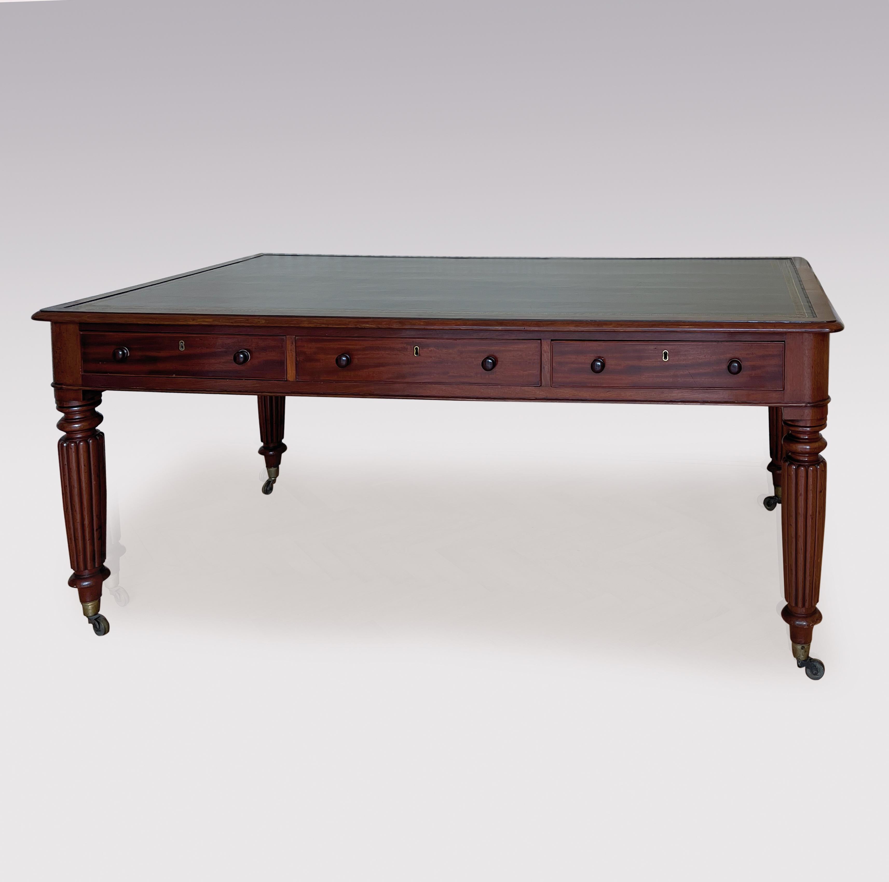 A large mid 19th century Mahogany writing having black gilt tooled moulded edge rectangular top above six oak lined drawers, supported on reeded tapering legs ending on original brass castors.
