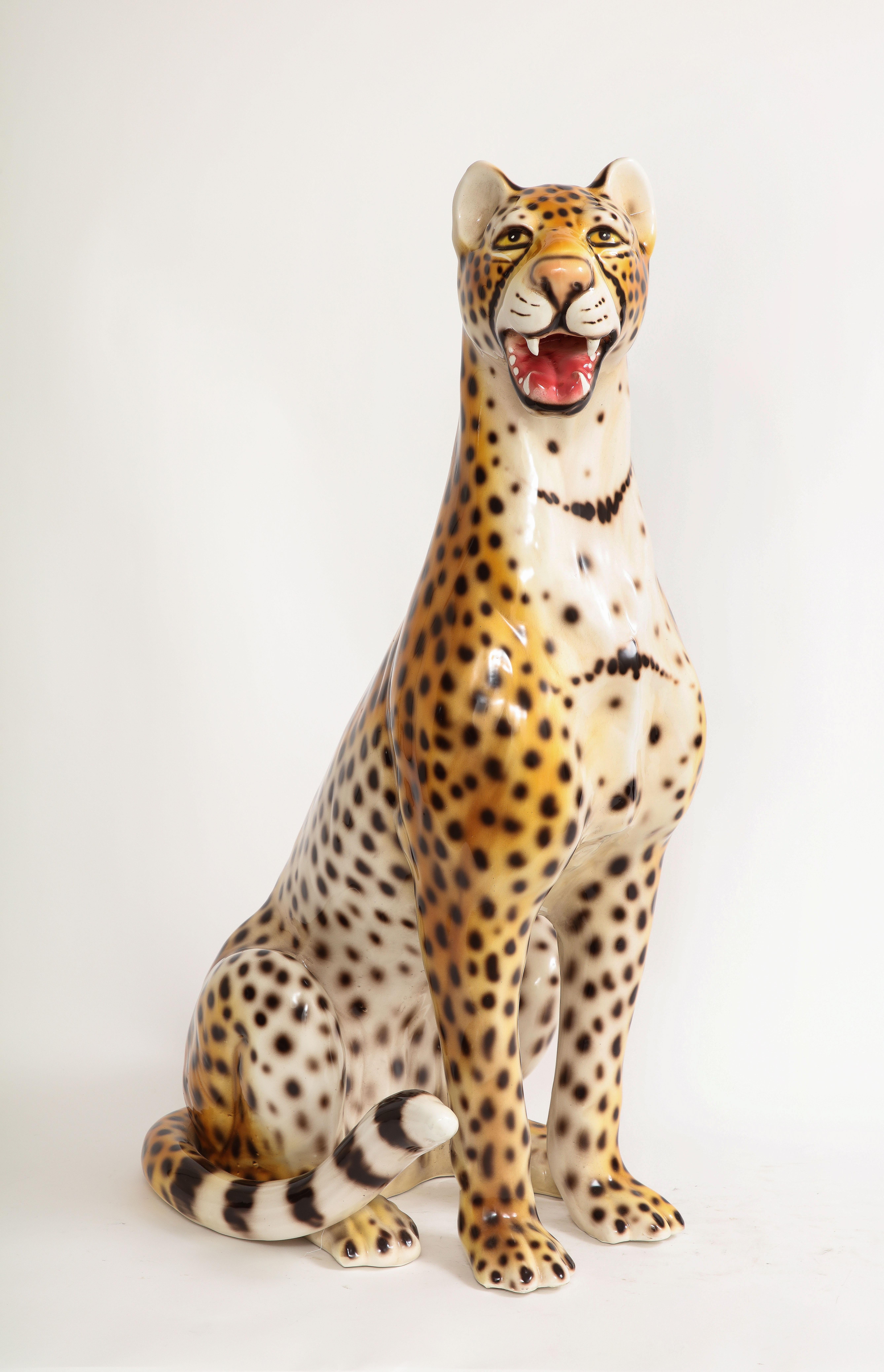 A Large Mid-Century Modern Italian ceramic sculpture of a seated Jaguar. This marvelous large jaguar is made of high-quality hand-painted ceramic. It looks very dignified and elegant. This figure is perfect match to the Hollywood Regency style.