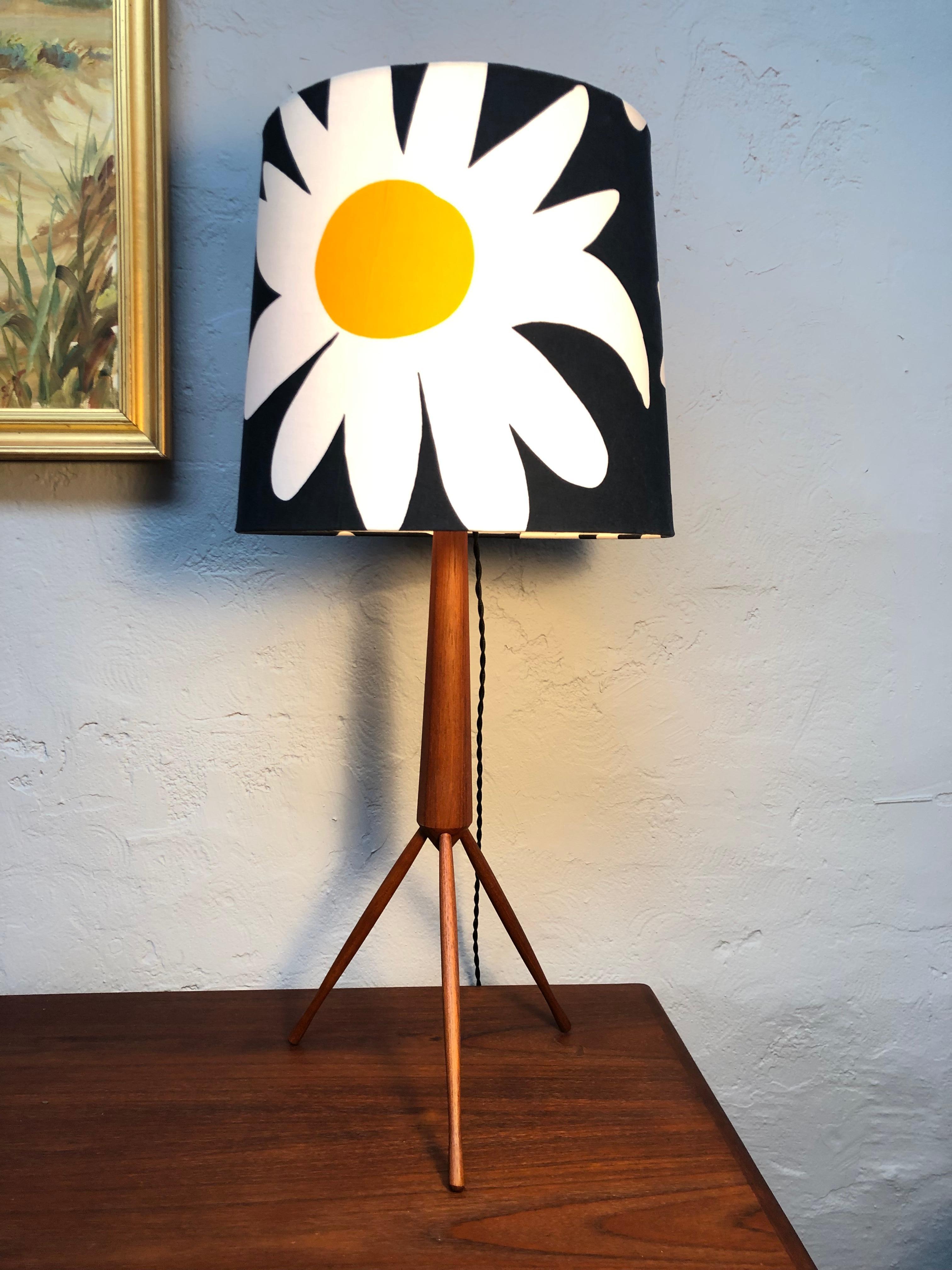 A large Mid-Century Modern teak tripod table lamp.
The body of the lamp is turned teak.
The three legs are slap turnés teak.
All of the teak has been sanded and waxed.
The lamp has the original Bakelite bulb holder with an on/off switch and