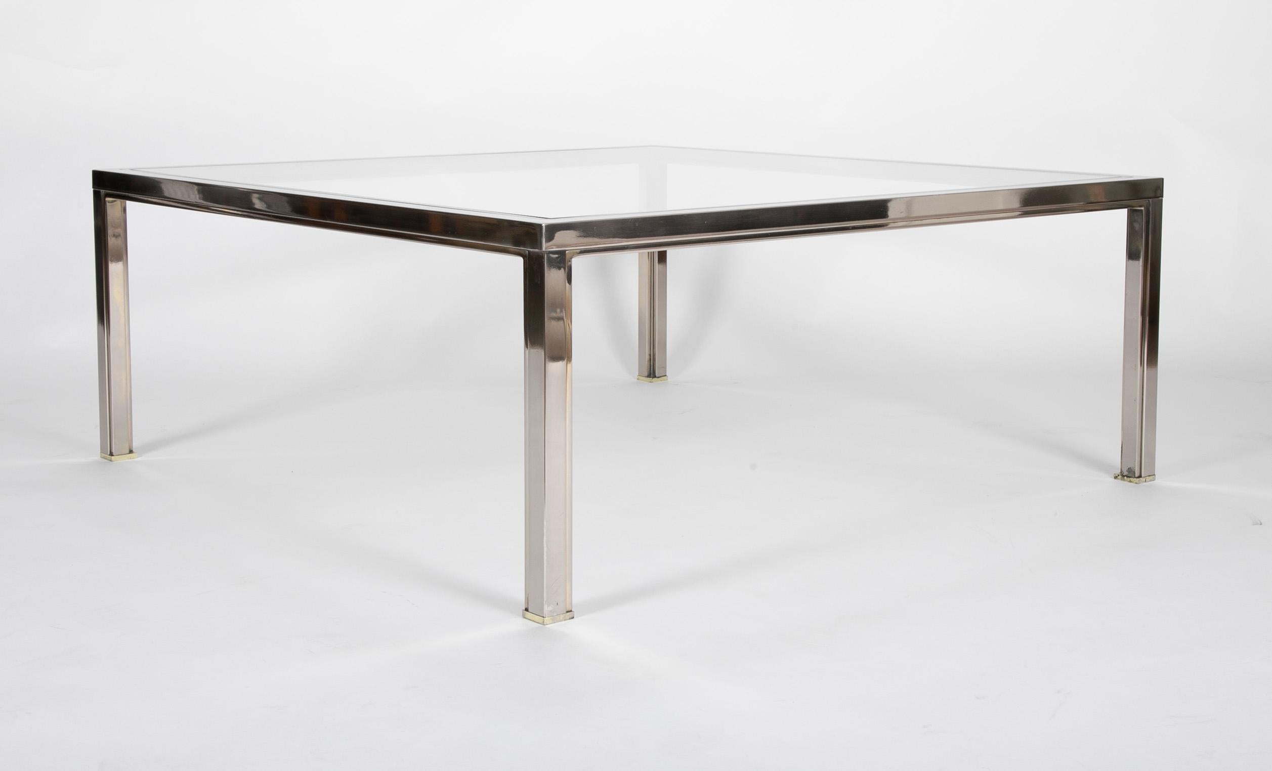 A steel and glass modern coffee table in the style of Romeo Rega. Measures: 43