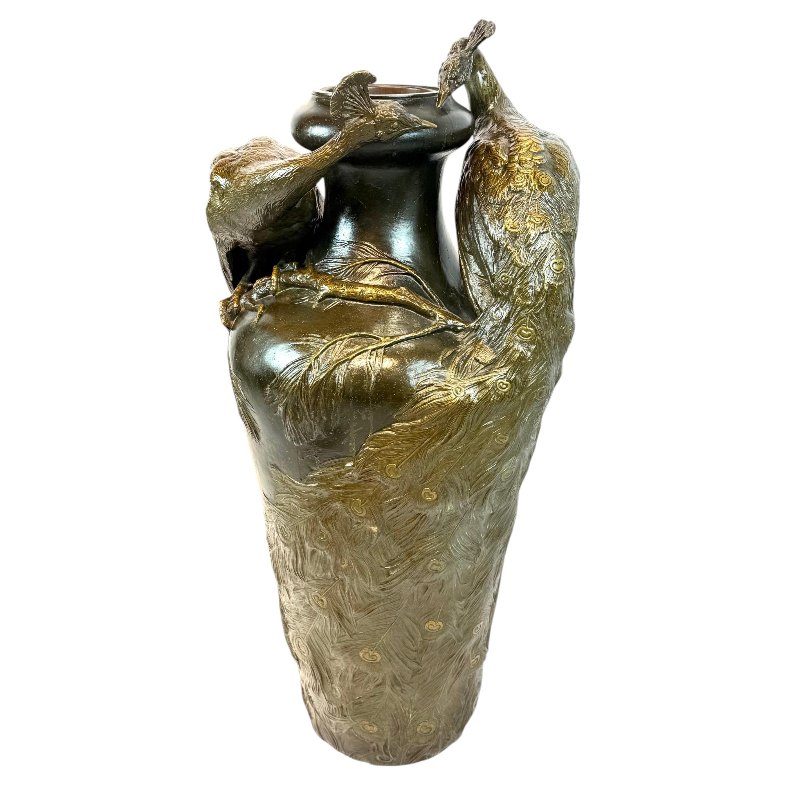 A large monumental Art Nouveau bronze peacock vase