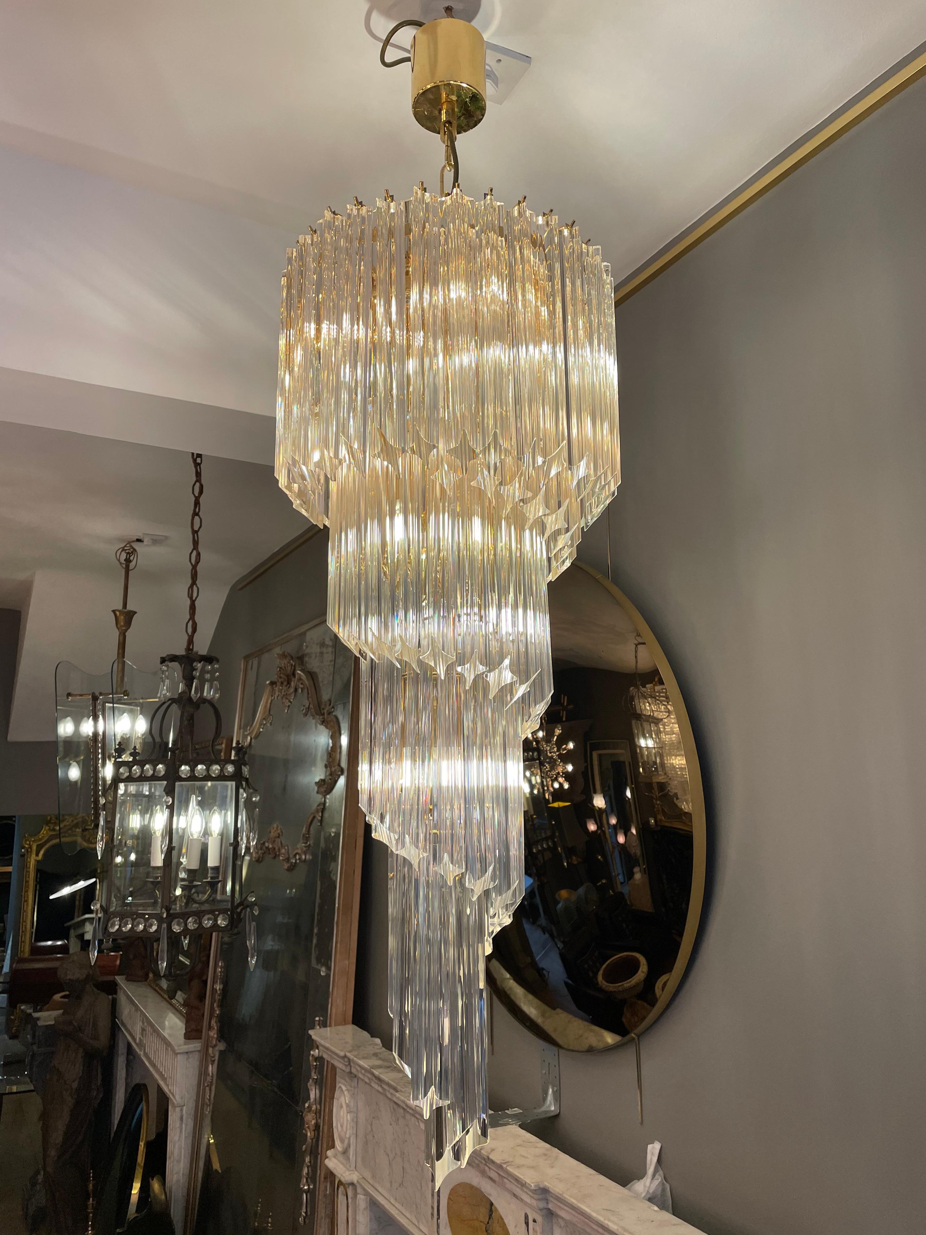 A large spiral Murano chandelier by Novaresi Italy. Having 8 light fittings, 5 tiers and a brass frame. Late 20th century. Lots of spare glass included.