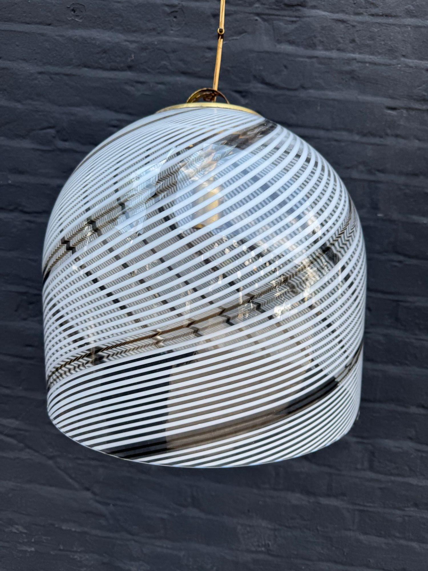 A large Italian 1970s Murano glass pendant light by Venini with white and bronze Tessuto swirl design and brass top fixing and ceiling rose. Re wired with new brass fittings, antique cord flex and PAT tested