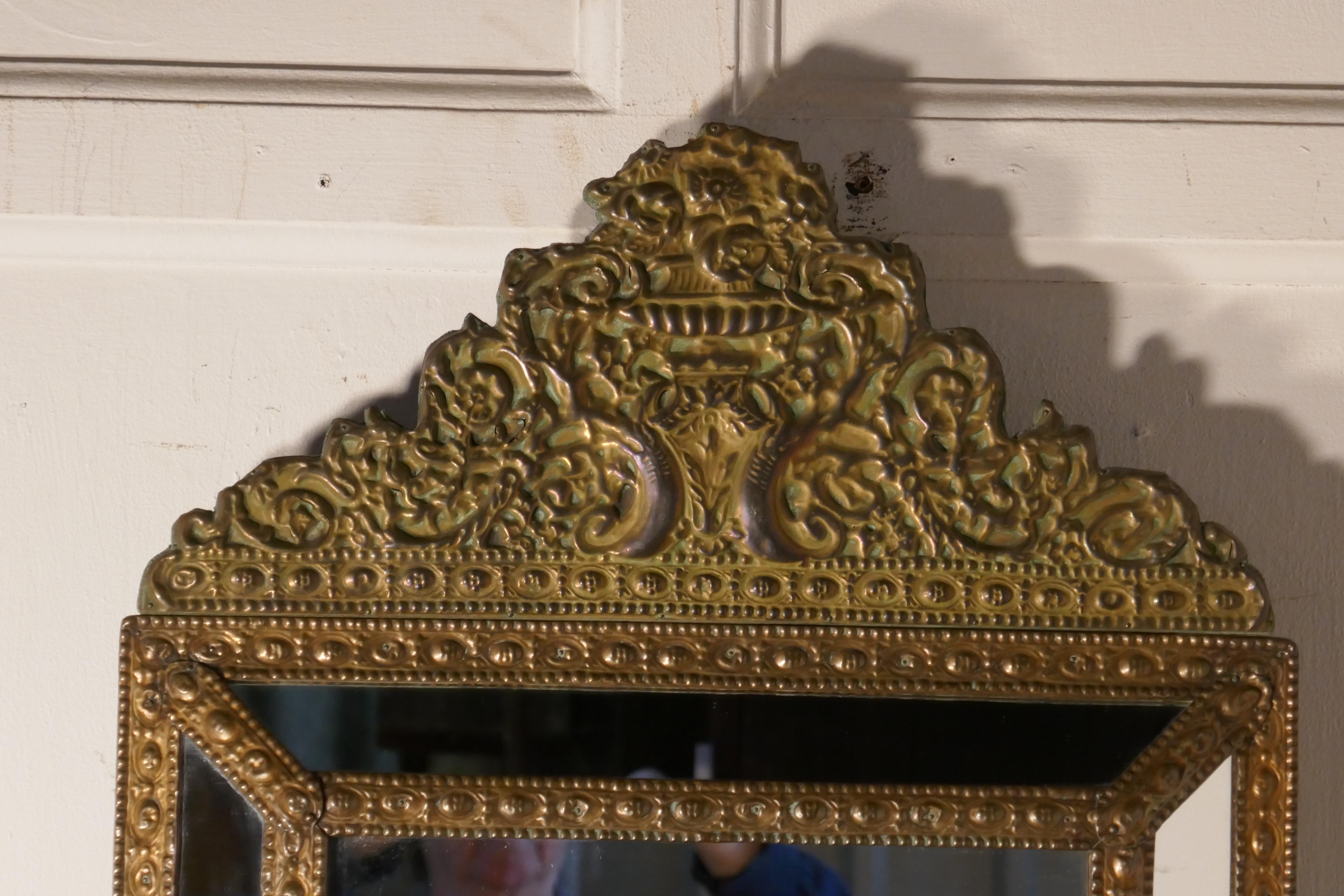 A large Napoleon III French bass cushion mirror

This is a small version of this type of mirror, the beaten brass frame is profusely decorated with flowers
The mirrors are all original, and the brass has taken on a charming verdigris