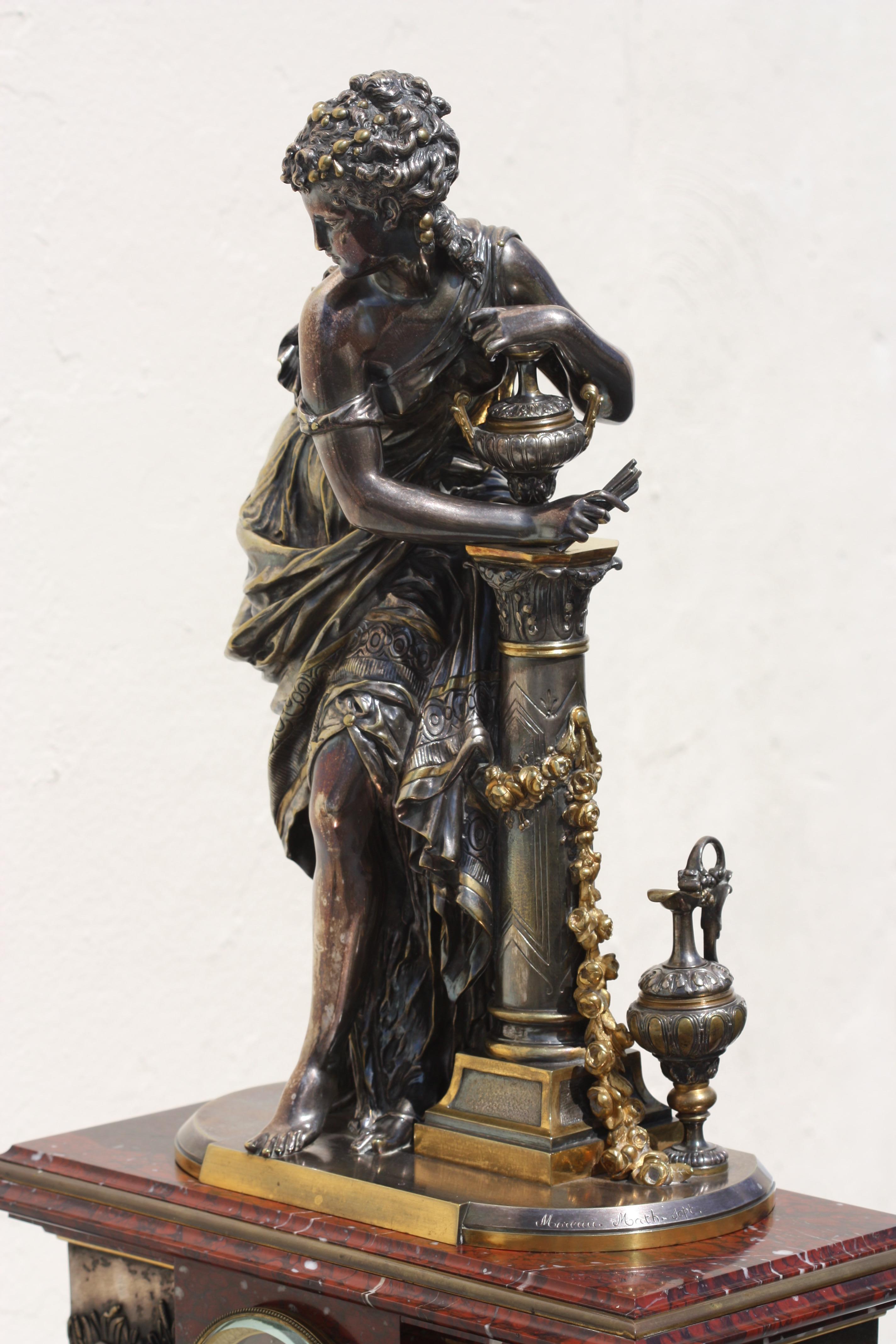 Grande garniture de pendule Napoléon III en marbre Rouge griotte, argenté et bronze doré
Paris, vers 1880
moulage d'après un modèle de Mathurin Moreau (1822-1912)
Comprenant une horloge et une paire de candélabres à six lumières
signé ;
Moreau