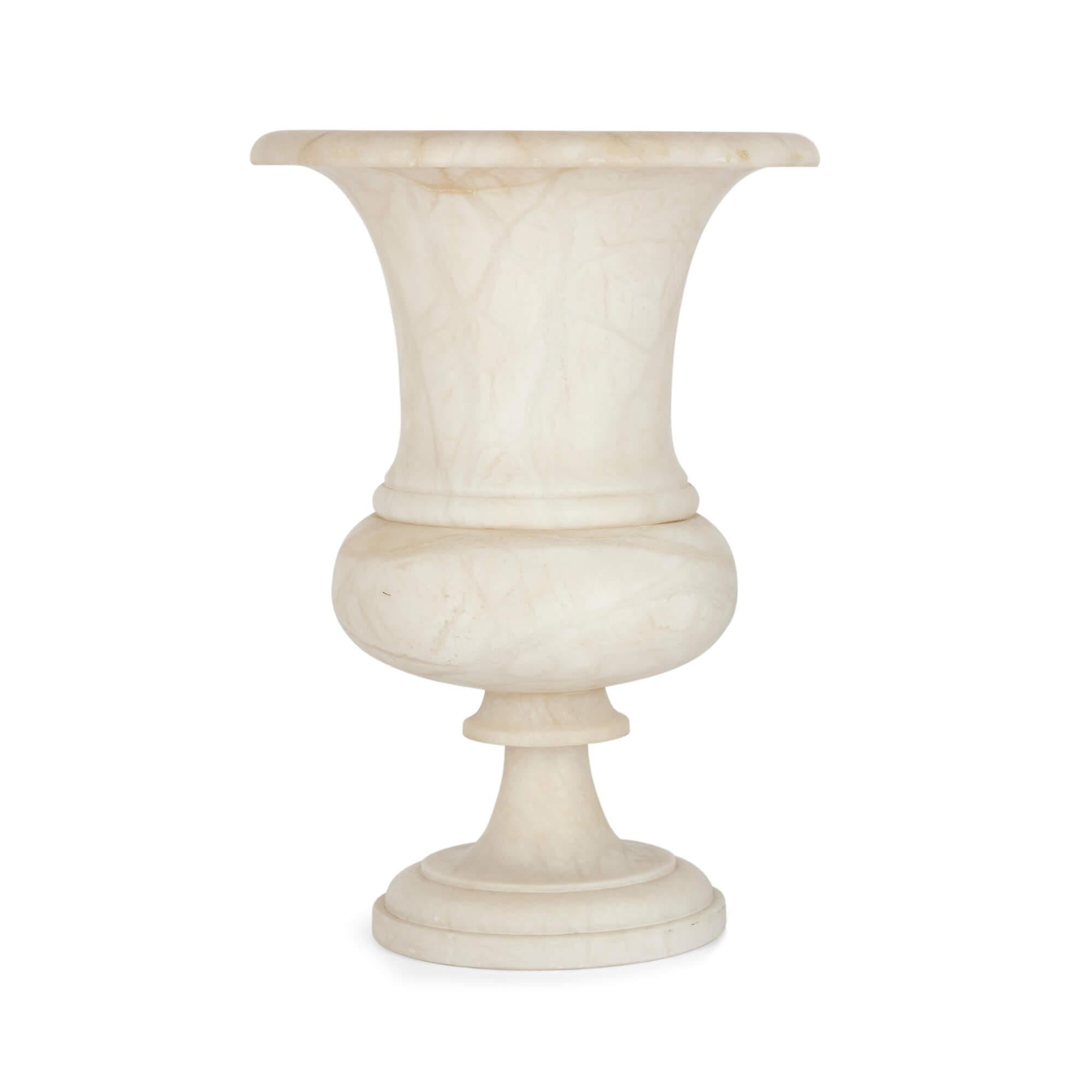 A large alabaster campagna-shaped vase
Continental, 20th century
Measures: Height 34.5cm, diameter 24cm

In a distilled neoclassical style in the so-called campagna shape, this fine vase is made from alabaster, a fine-grained, white, and lightly
