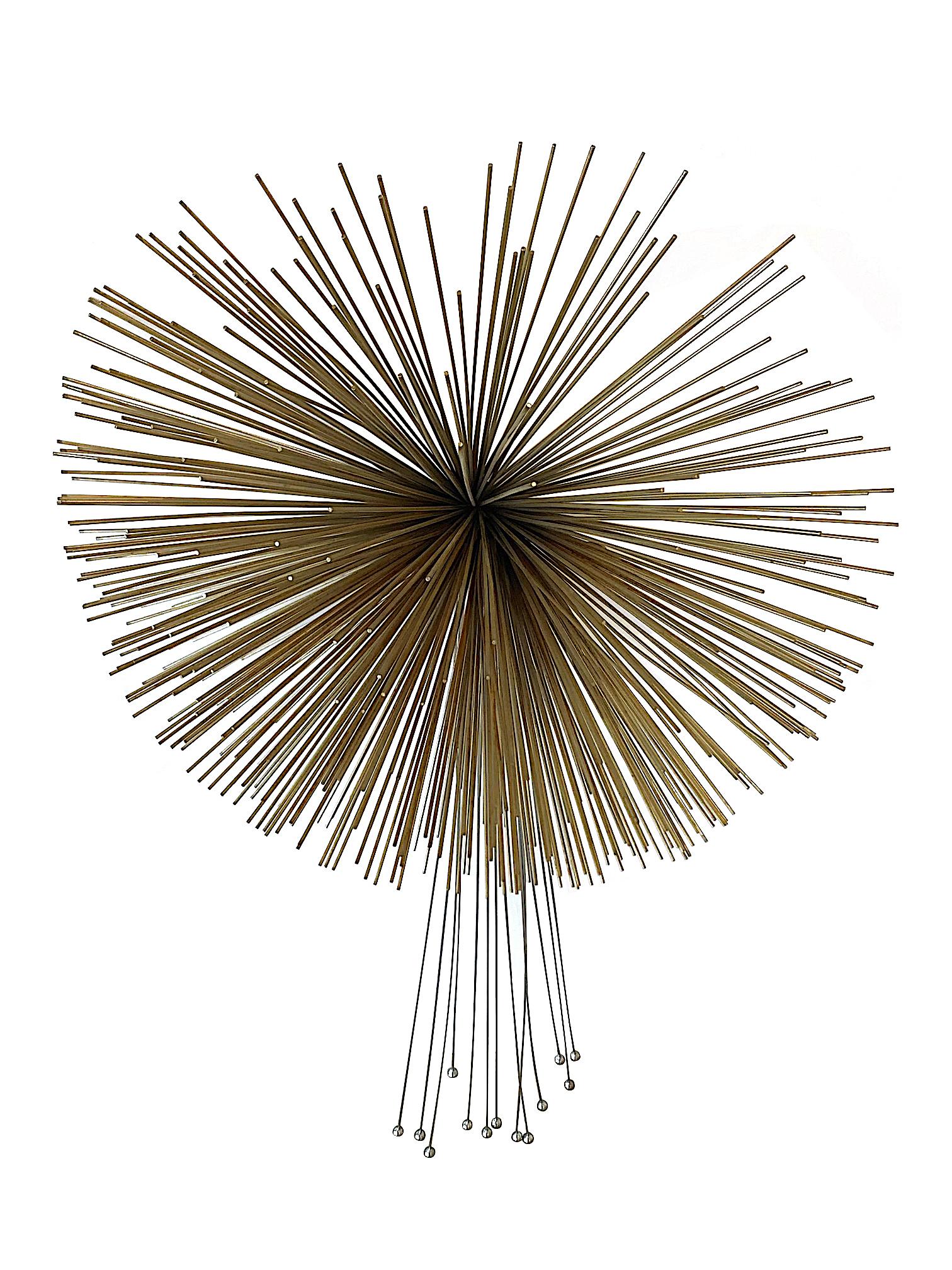 A large Curtis Jere brass and metal flying comet wall sculpture with central brass pom pom and chrome metal tail, signed and dated 