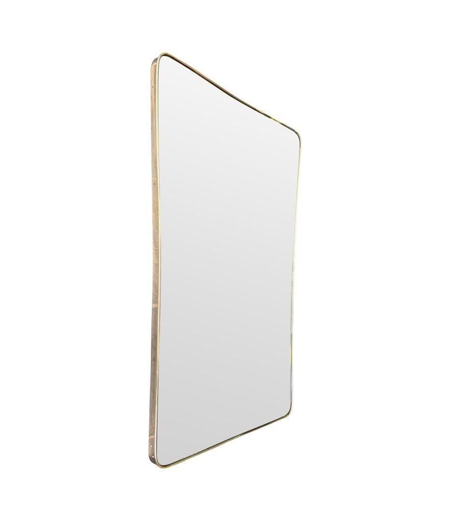 A large original shaped Italian 1950s brass framed mirror with original bevelled mirror plate and solid wood back.