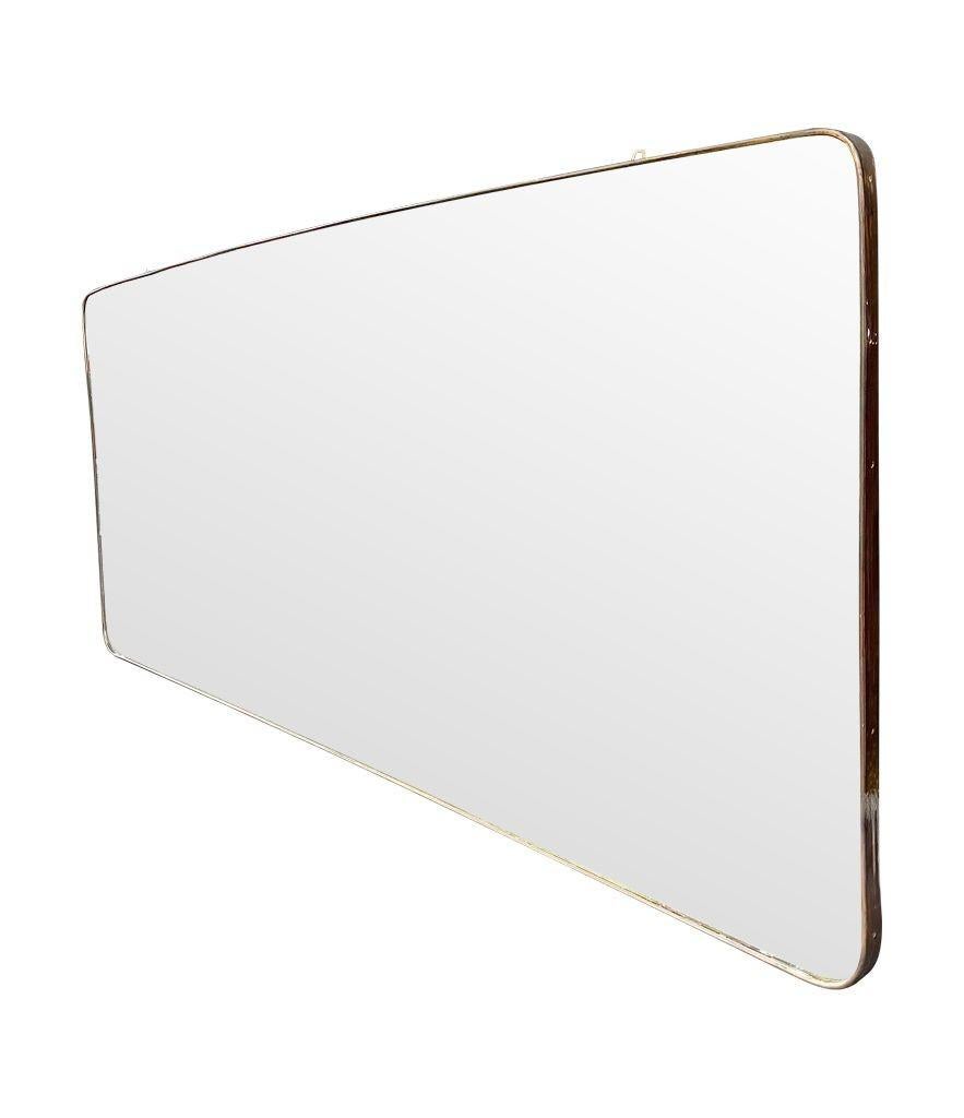 A large orignal 1950s Italian brass framed landscape mirror with curved corners, orignal mirror plate and solid wood back. The patina on the brass is orignal and dark, but could be polished up if required. 