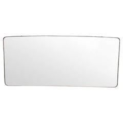 A large orignal 1950s Italian brass framed landscape mirror with curved corners