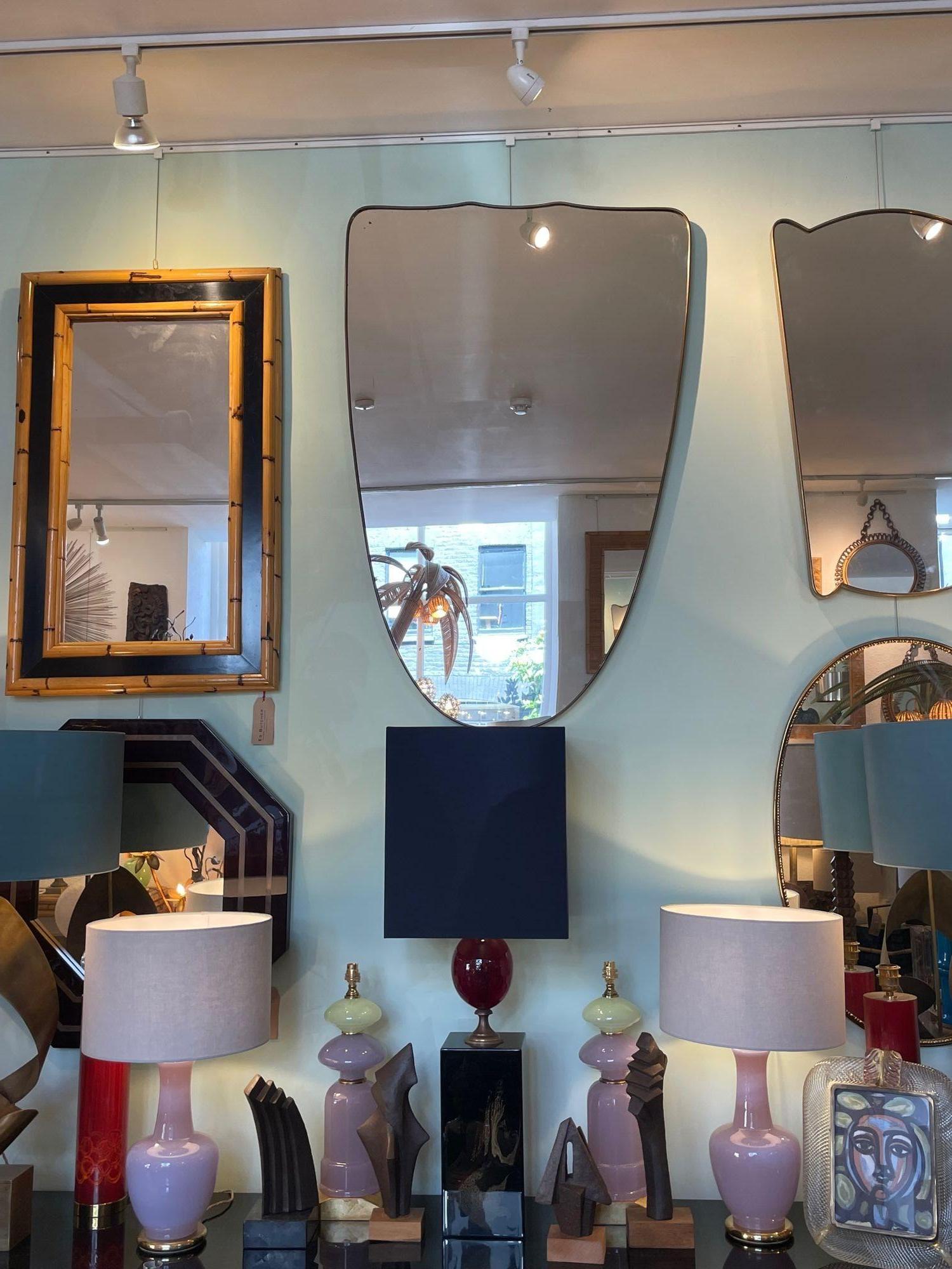 A large orignal Italian 1950s shield mirror with brass frame For Sale 3