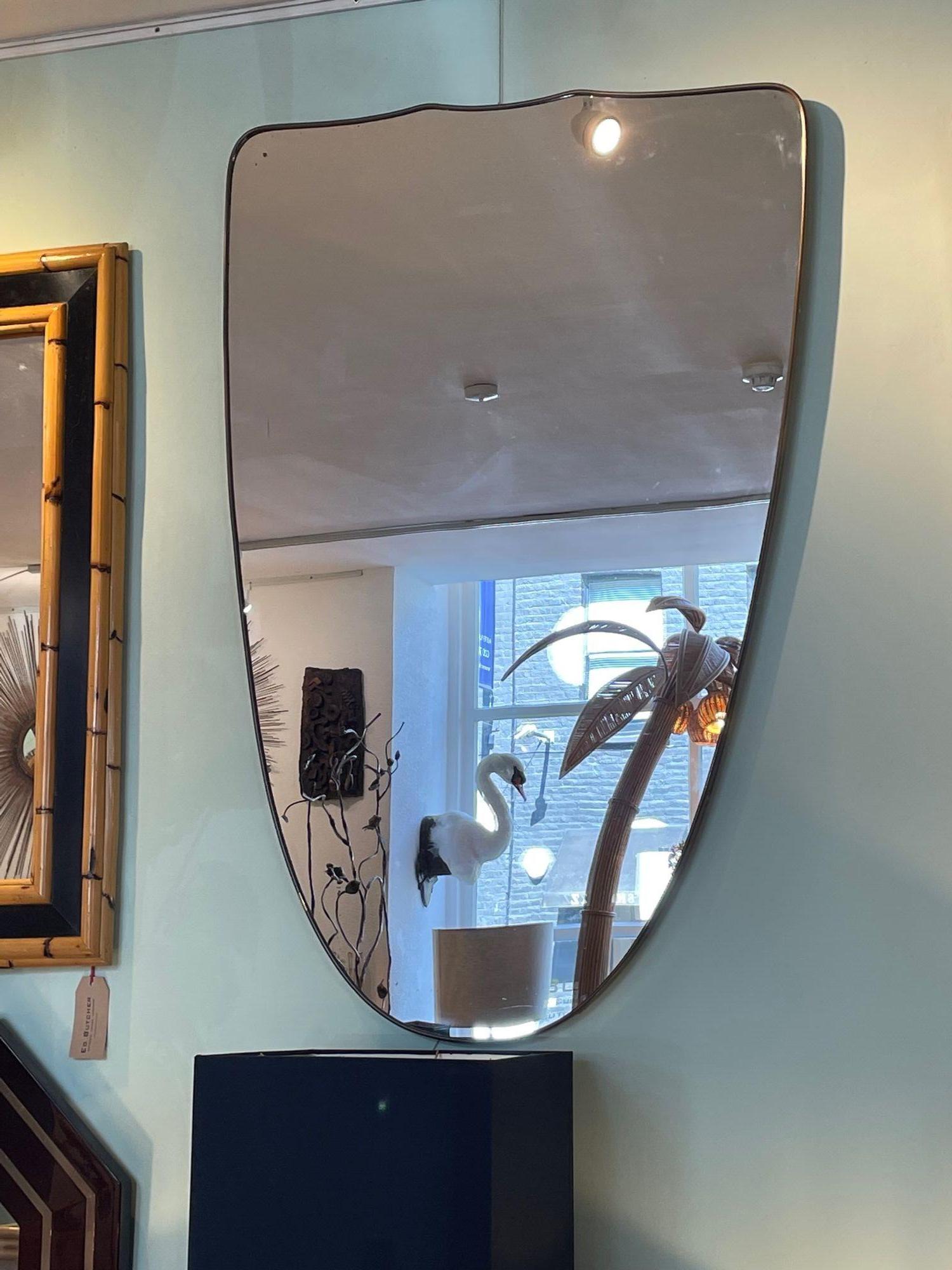 A large orignal Italian 1950s shield mirror with brass frame For Sale 5