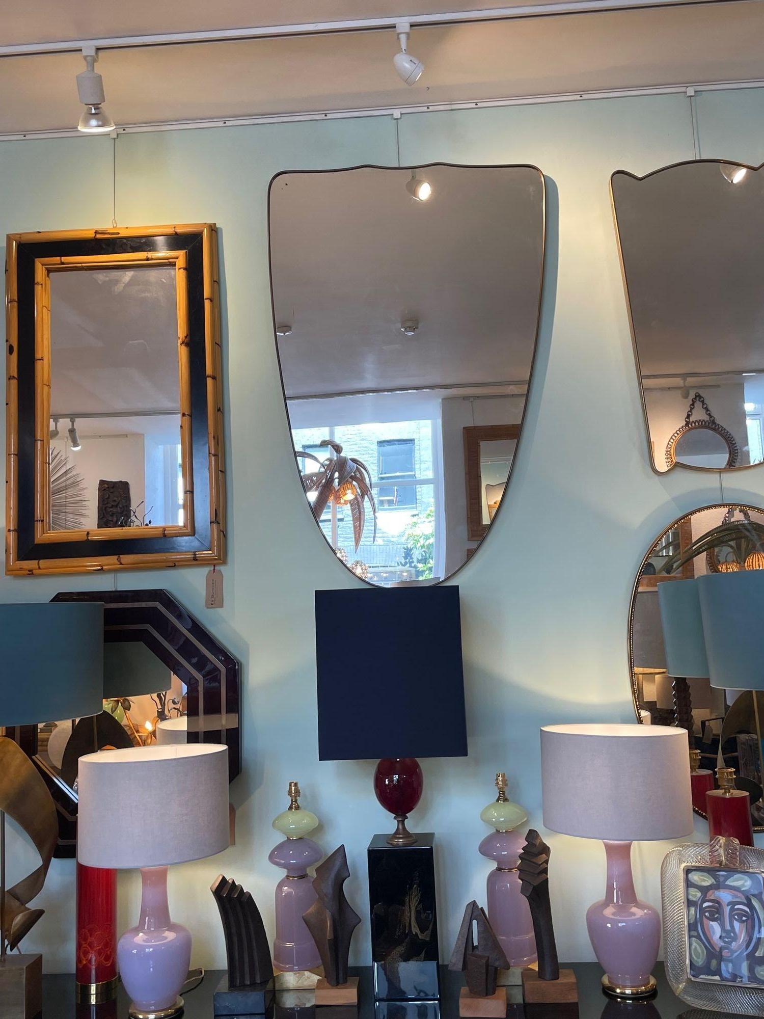 Mid-Century Modern A large orignal Italian 1950s shield mirror with brass frame For Sale