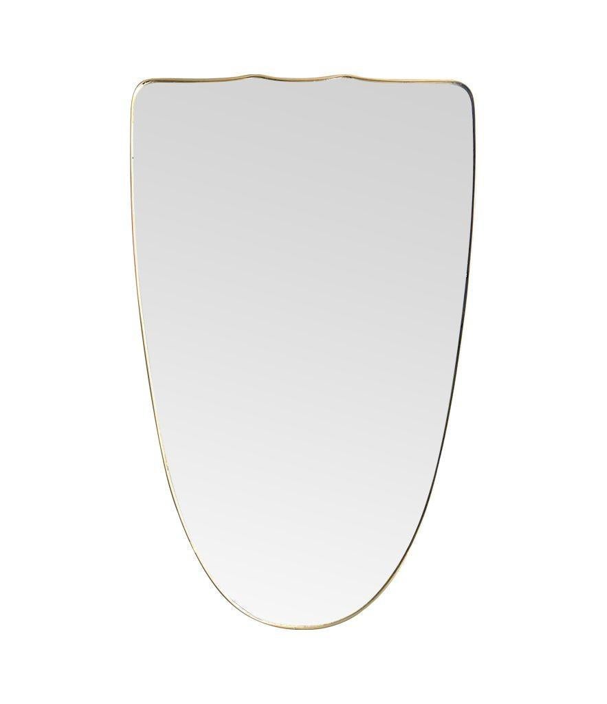 A large orignal Italian 1950s shield mirror with brass frame In Good Condition For Sale In London, GB