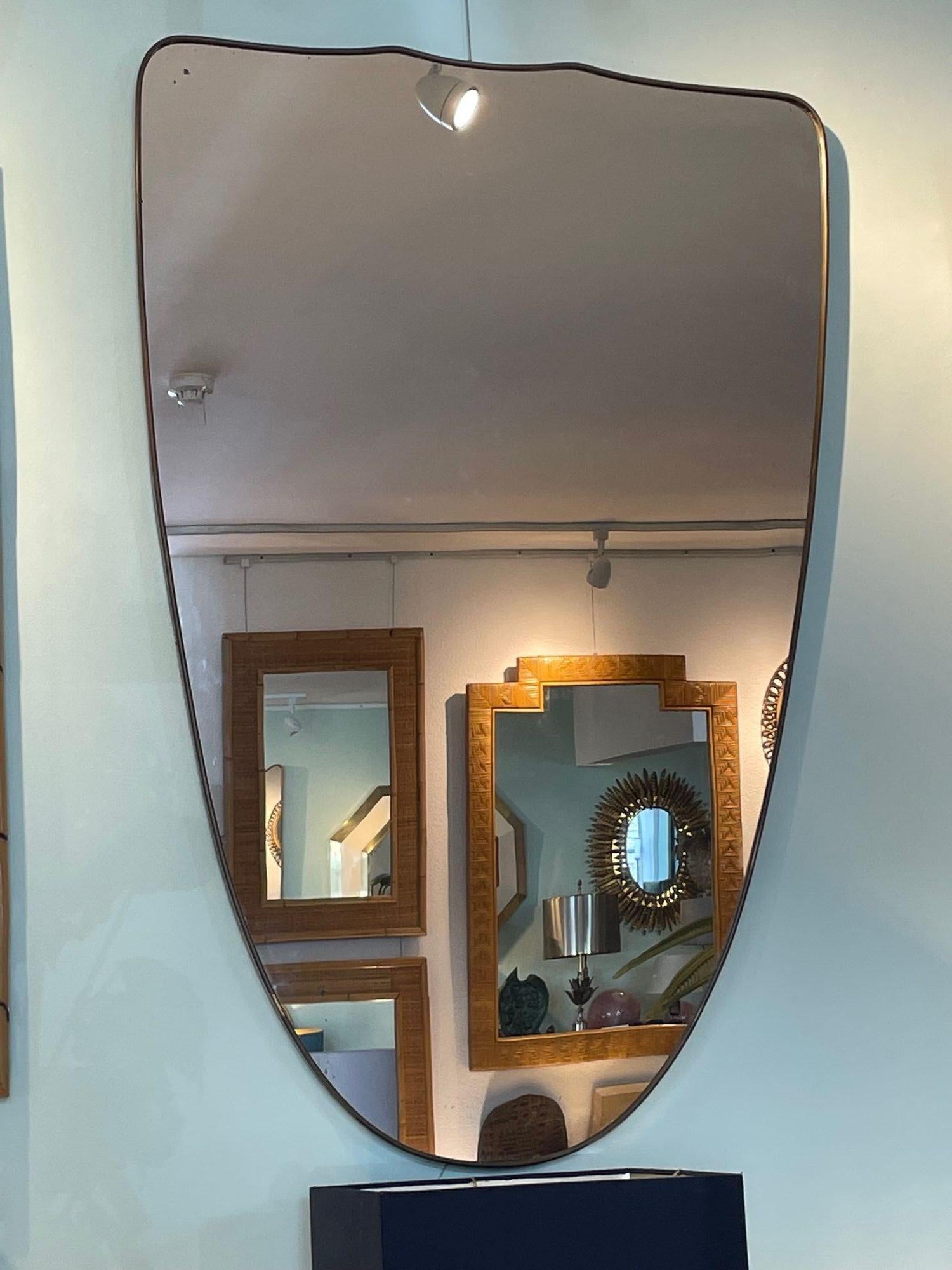 Mid-20th Century A large orignal Italian 1950s shield mirror with brass frame For Sale