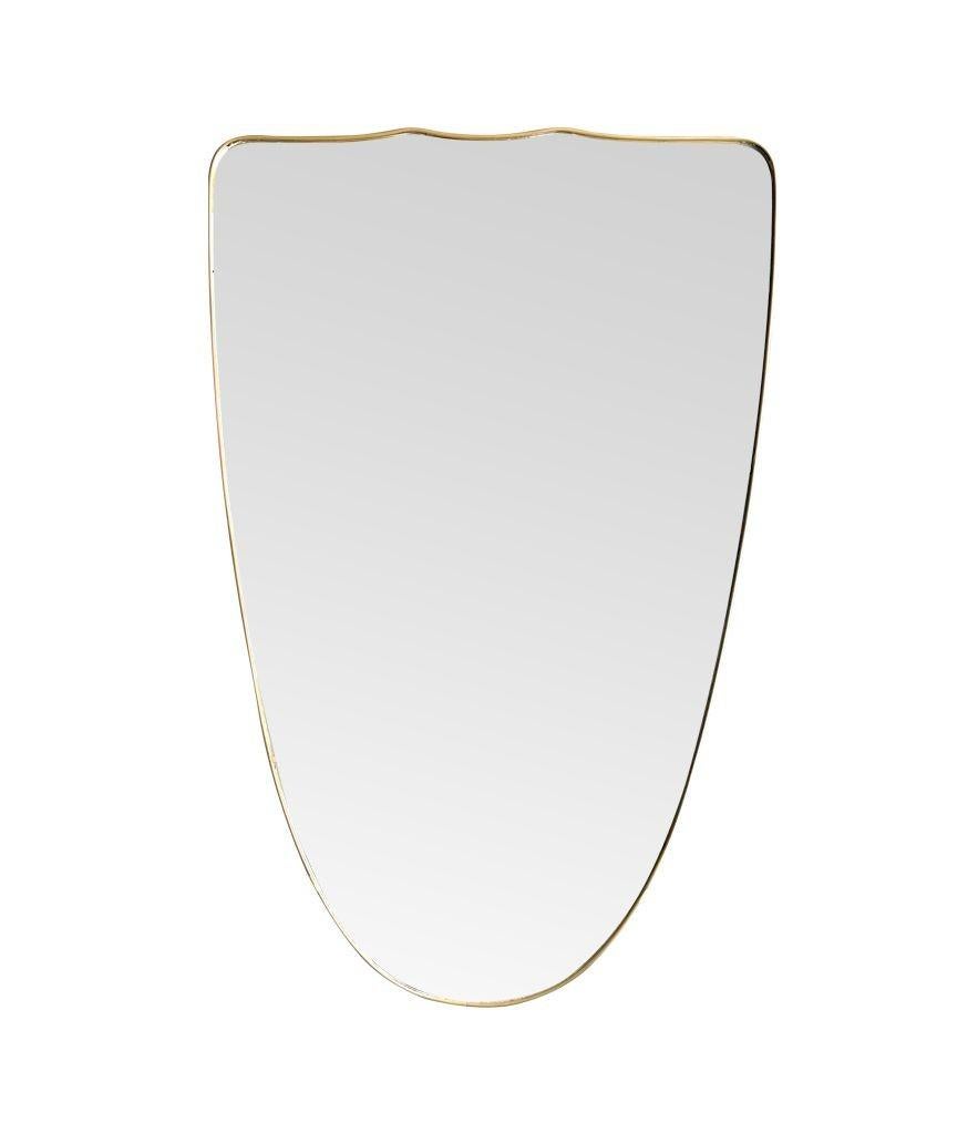 Brass A large orignal Italian 1950s shield mirror with brass frame For Sale